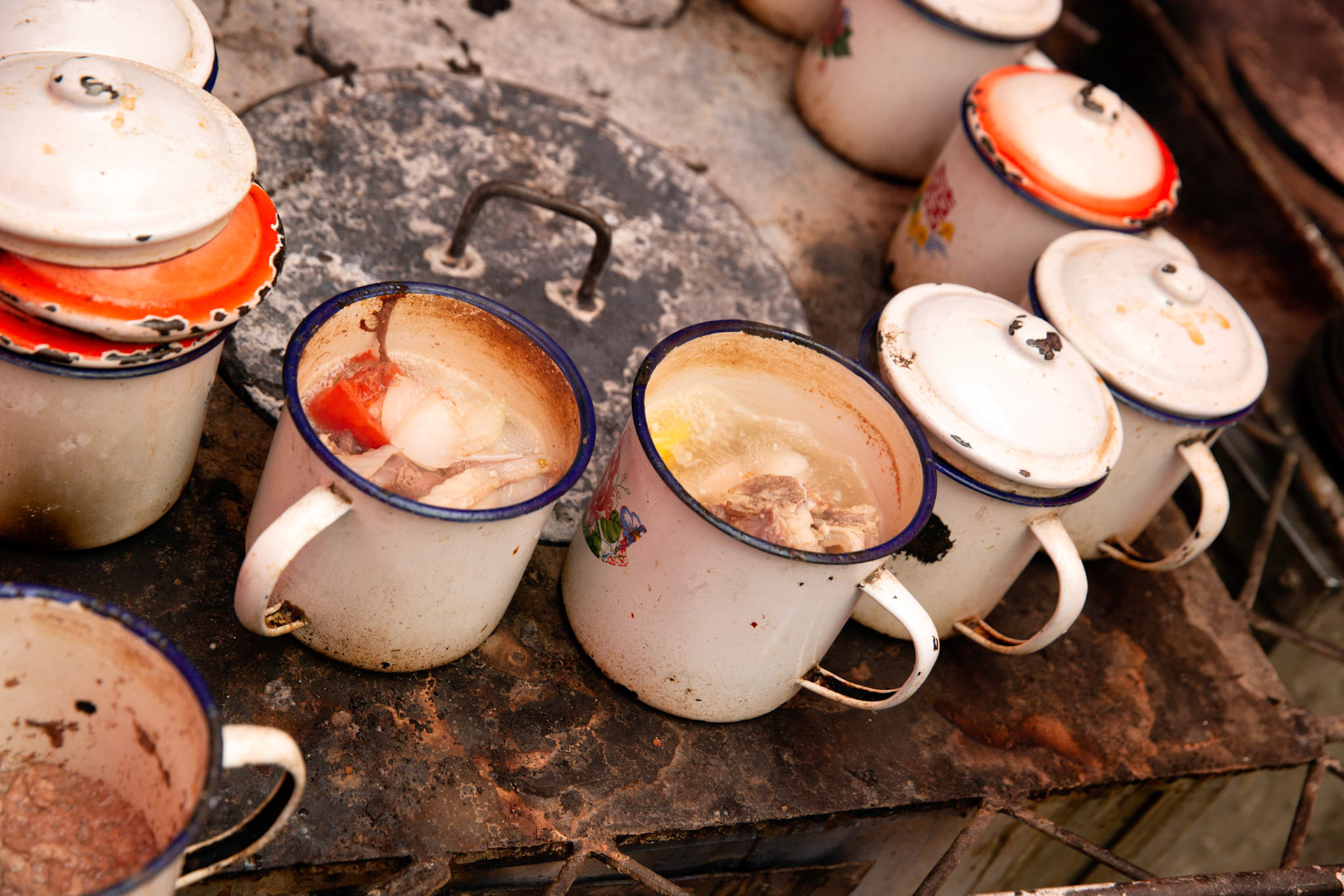 Mugs with lamb soup on  a stove in the Kashgar Grand Bazaar.