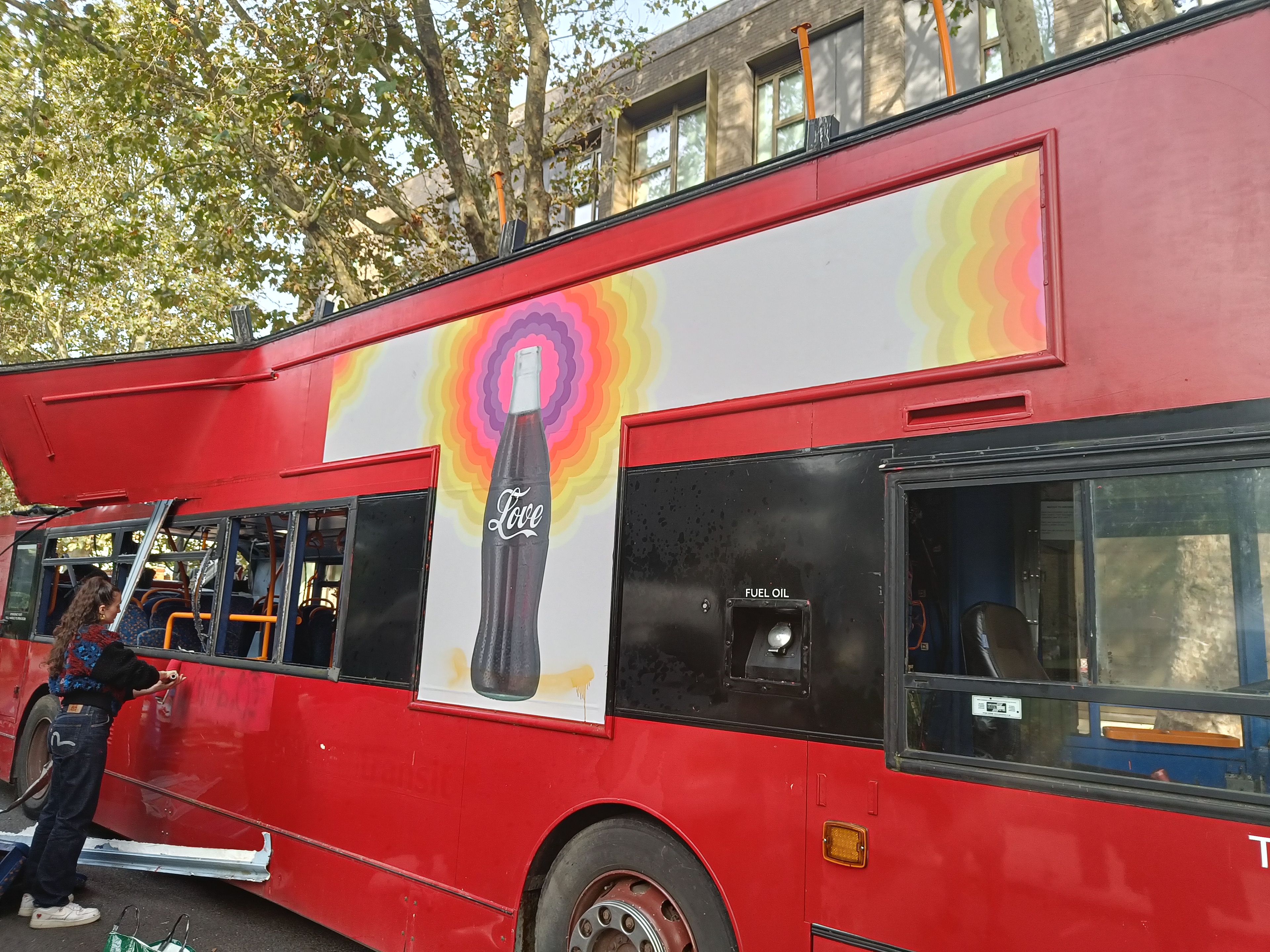 Vinyl decal application on side of an old bus
