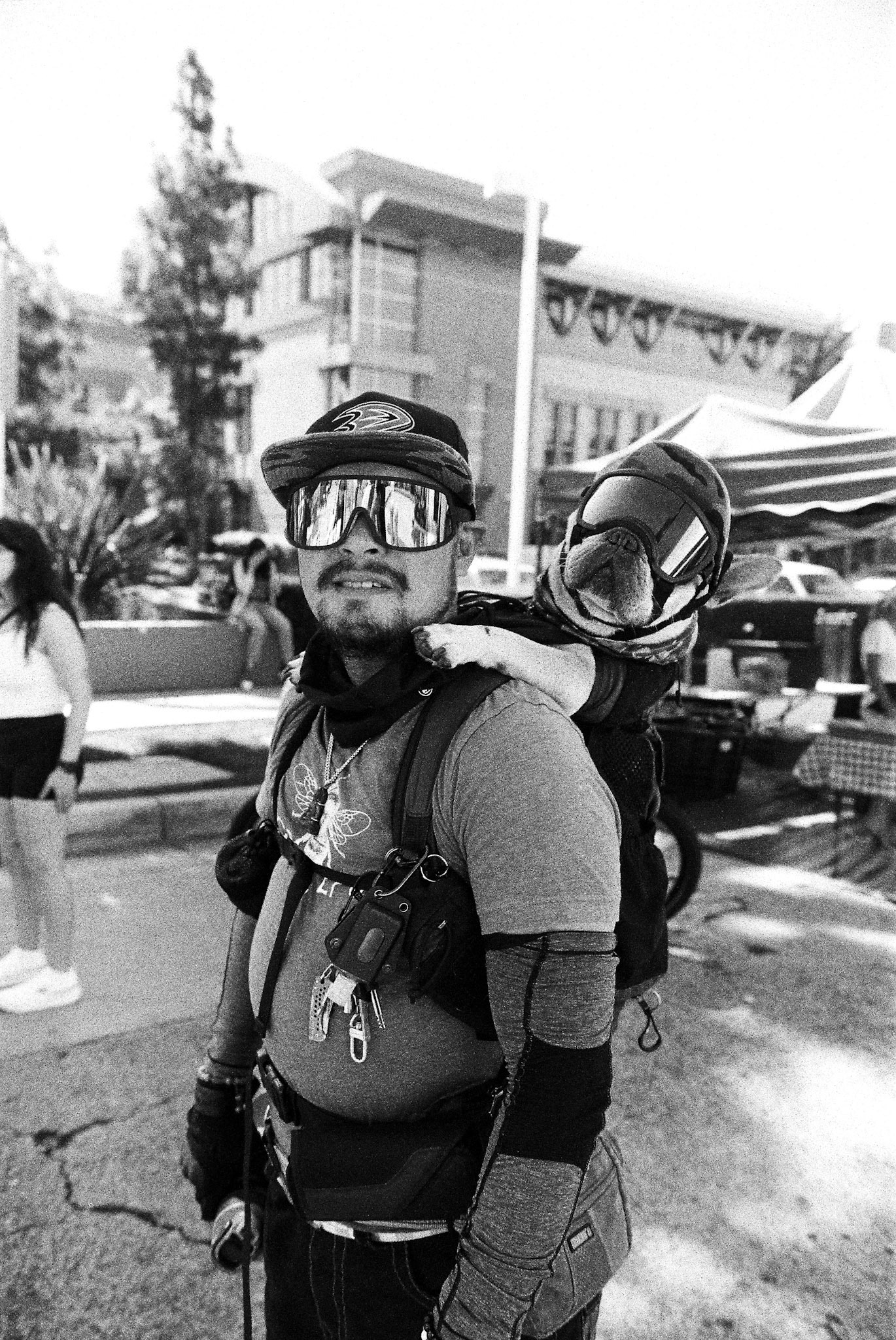 A Man with his dog strapped to his back at the Orange Farmers Market on Sep. 7th, 2025. Credit: Efrem Plawner, VOICE OF OC