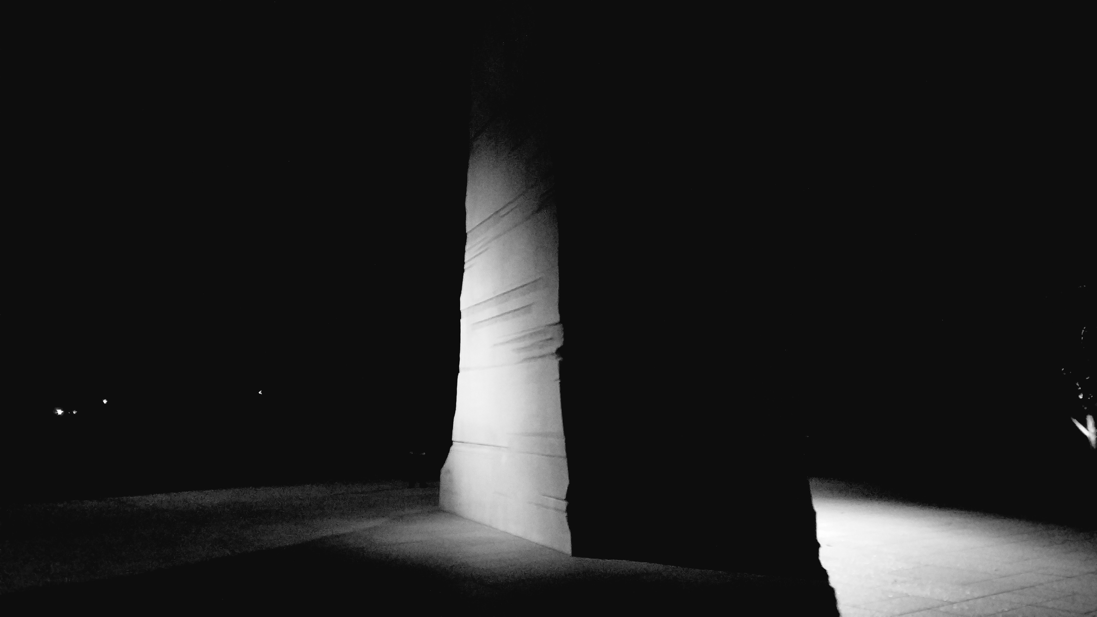 Light and shadow on the Martin Luther King, Jr. Memorial at night.