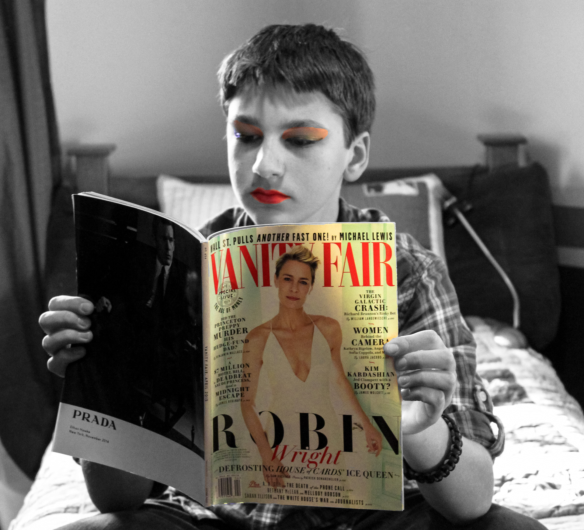 A partially colored photograph of a young white boy wearing red lipstick and orange eyeshadow. He is sitting on a made bed reading a copy of Vanity Fair with Robin Wright on the cover. The magazine cover and his make-up are the only things in color. Robin Wright has short cropped blonde hair and is wearing a white dress with a plunging neckline. The boy is wearing a plaid shirt with the sleeves rolled up to the elbow. He had a cord bracelet on his right wrist. The bed has a wood headboard.