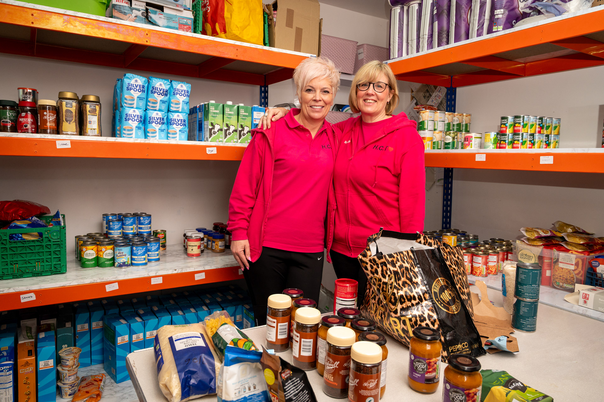 Hayley Thomas, left, founder and trustee of The Helping Caring Team Charity, HCT, and Sarah Browne, right, who works in the Food bank HCT Pink Pantry. The Charity helps the homeless and vulnerable of Gwent from their Hub and shop on Bridge Street, Blackwood. The Charity which was set up seven years ago by Oakdale born Hayley, whose dad Ian Johnston was Gwent’s first Police and Crime Commissioner, has been at its current location for four years. As well as operating a food bank and meals service from its hub they also run the charity shop just up the street which helps fund the operation.