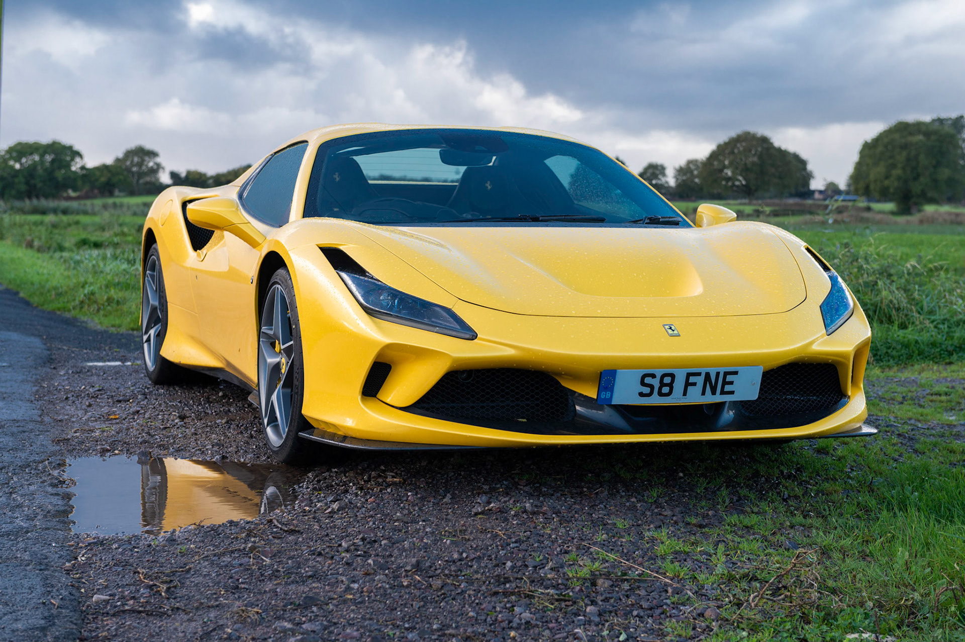 Yellow Ferrari F8 Spider photographed on the Gwent Levels, Castleton, South Wales, UK.