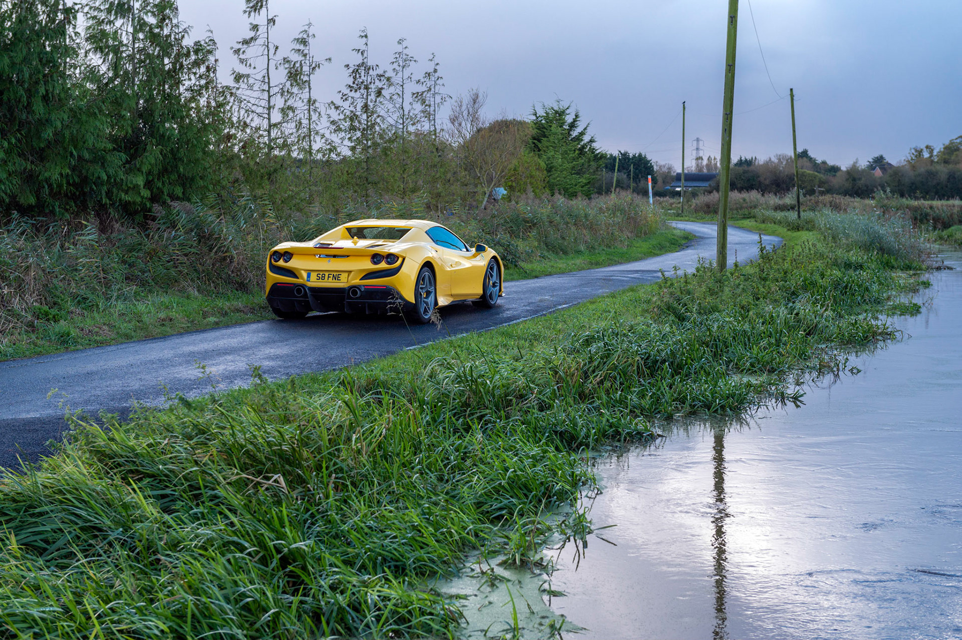 Yellow Ferrari F8 Spider photographed on the Gwent Levels, Castleton, South Wales, UK.