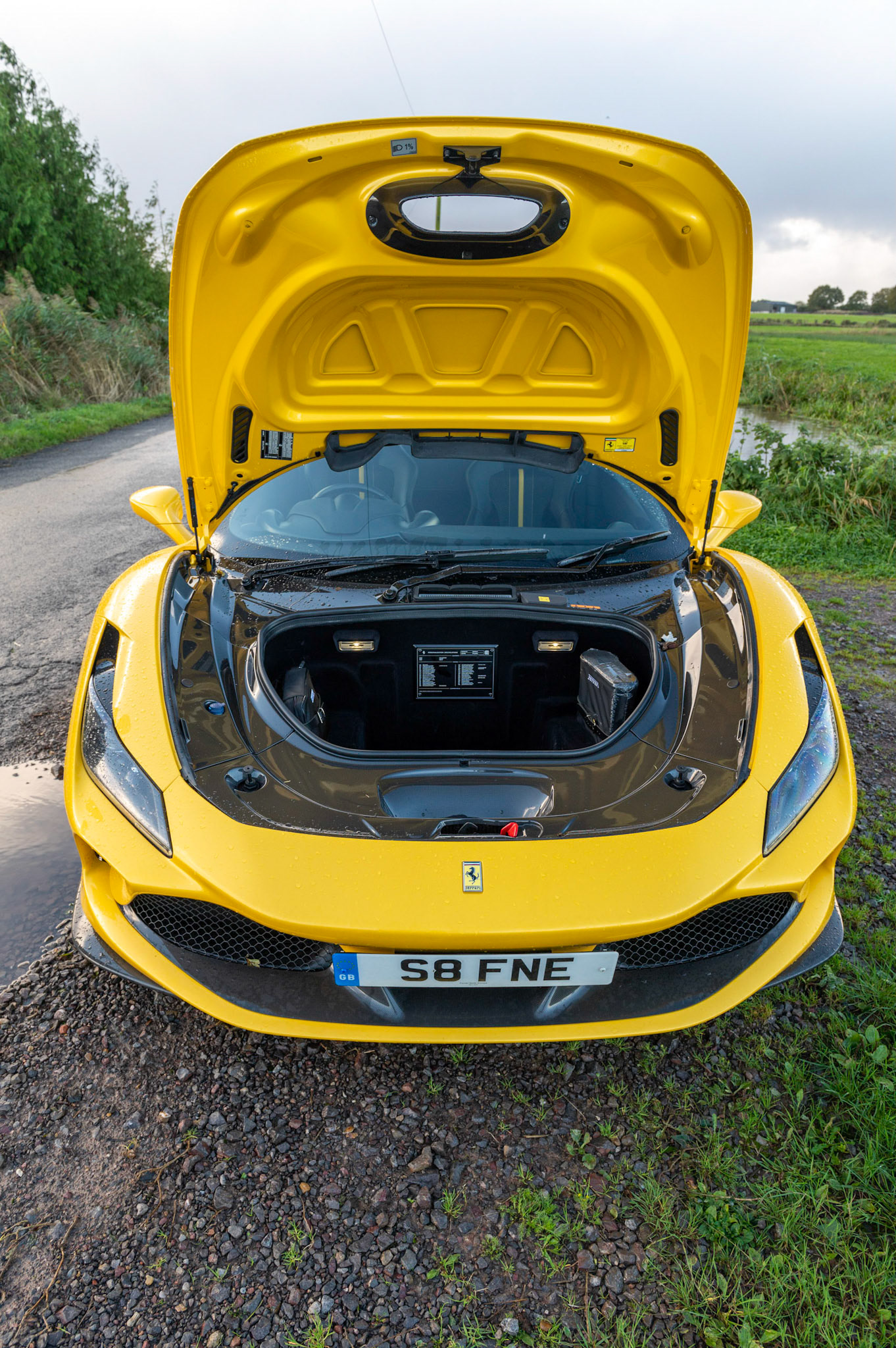 Yellow Ferrari F8 Spider photographed on the Gwent Levels, Castleton, South Wales, UK.