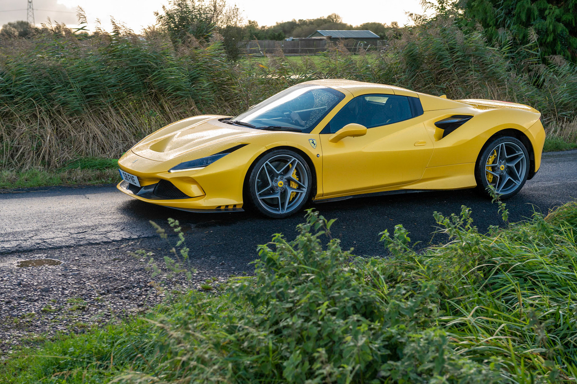 Yellow Ferrari F8 Spider photographed on the Gwent Levels, Castleton, South Wales, UK.