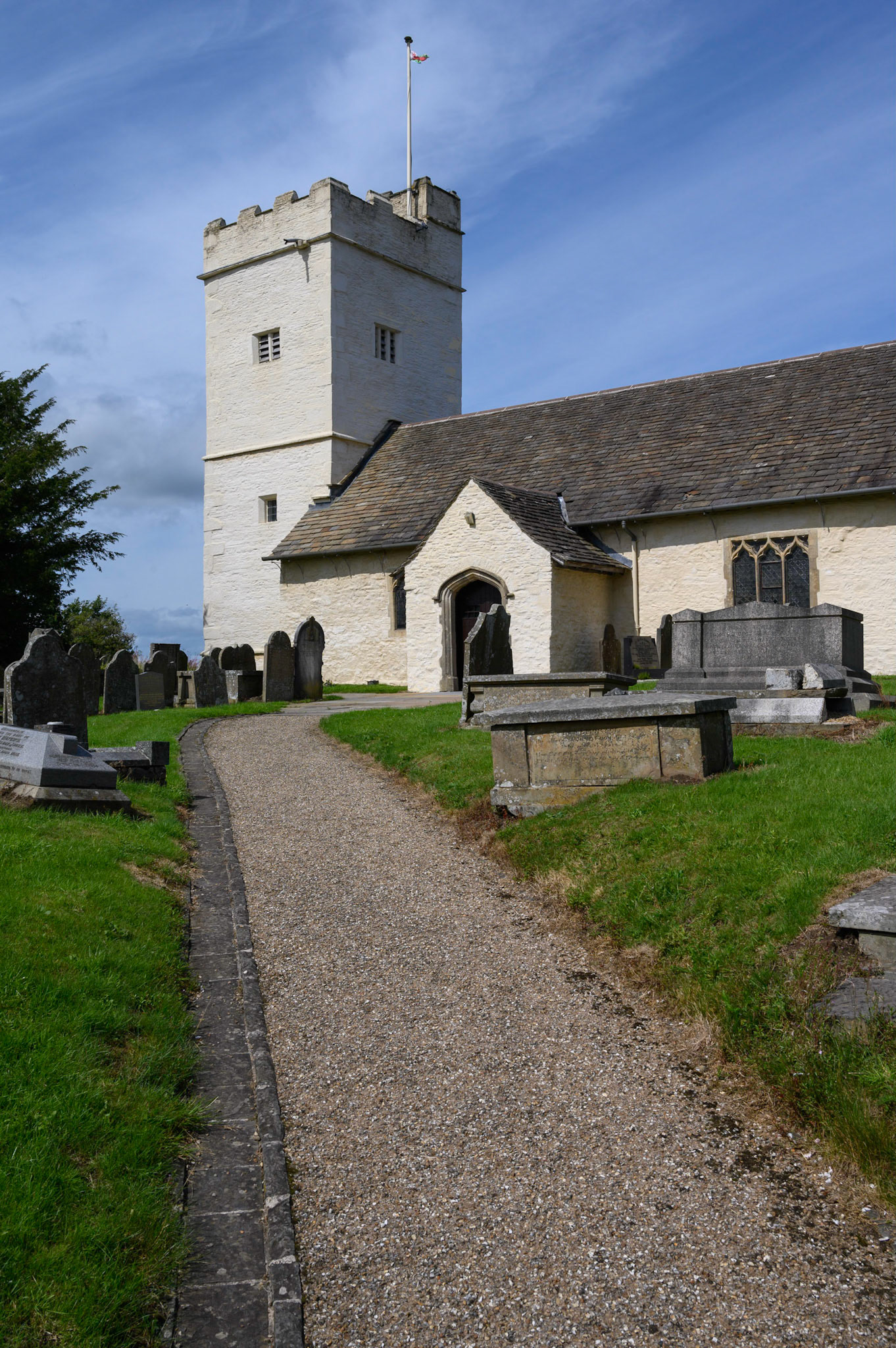 St Sannan’s Church and graveyard, Bedwellty, South Wales, UK against a blue summer sky.
