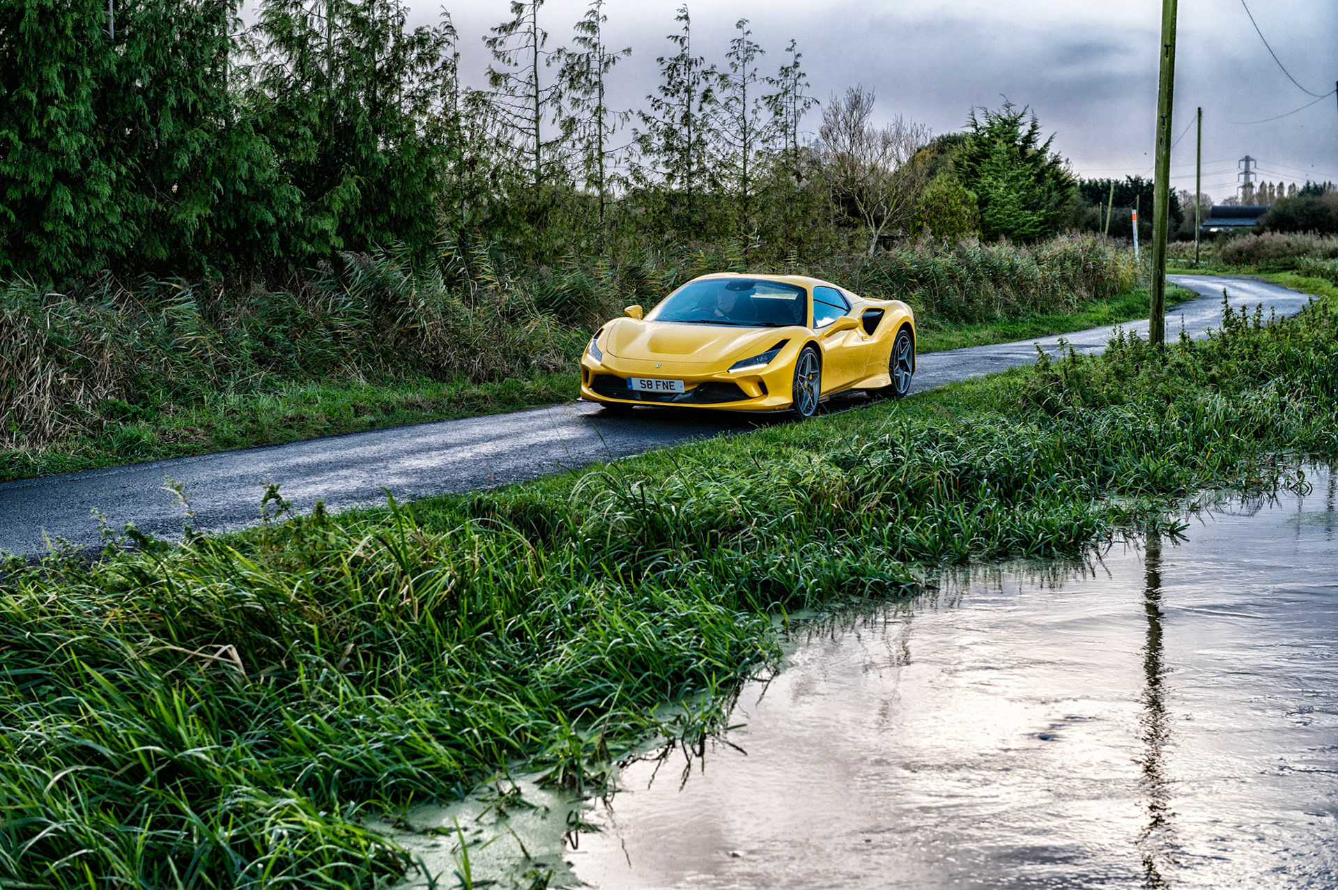 Yellow Ferrari F8 Spider photographed on the Gwent Levels, Castleton, South Wales, UK.