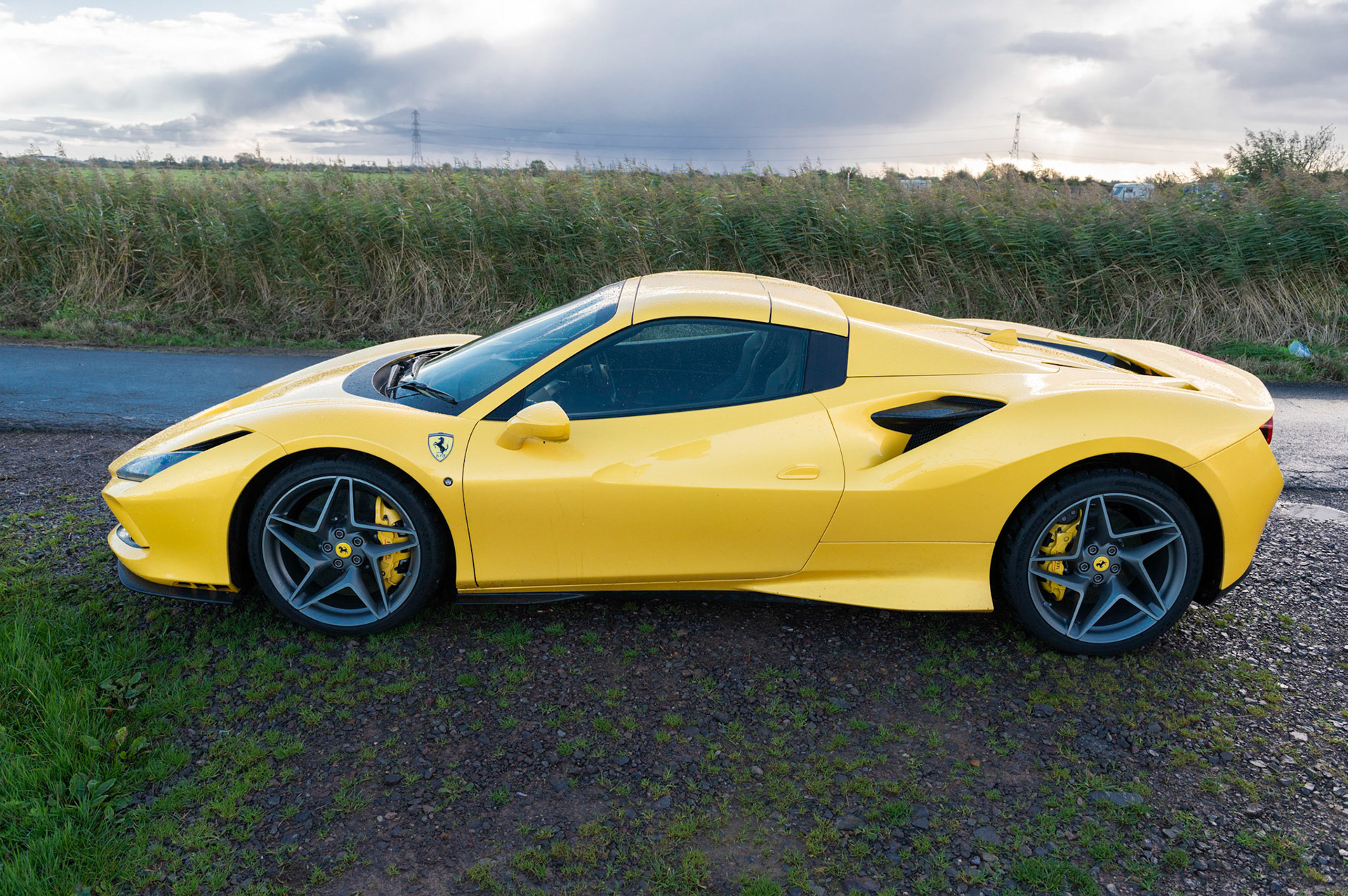 Yellow Ferrari F8 Spider photographed on the Gwent Levels, Castleton, South Wales, UK.