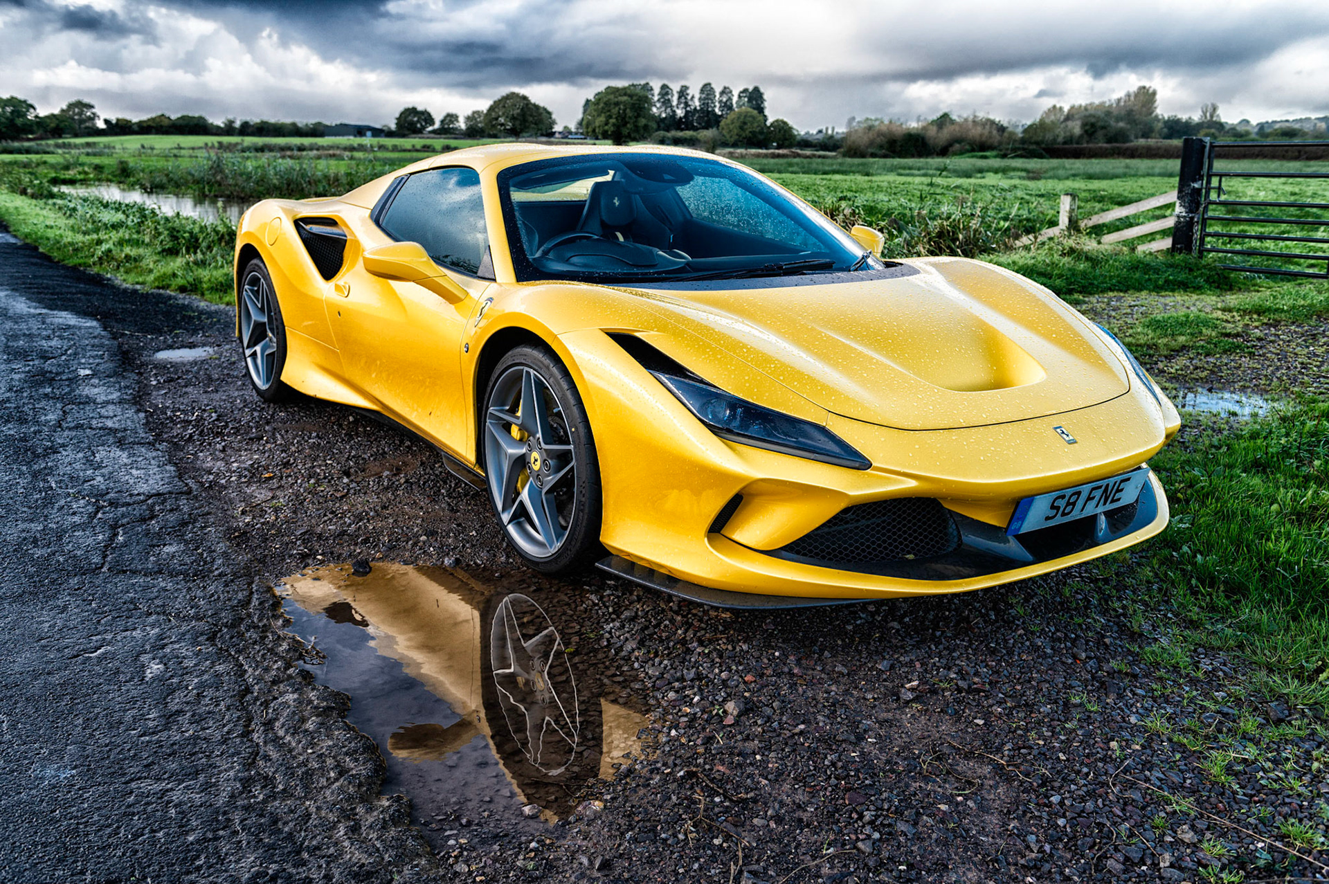 Yellow Ferrari F8 Spider photographed on the Gwent Levels, Castleton, South Wales, UK.