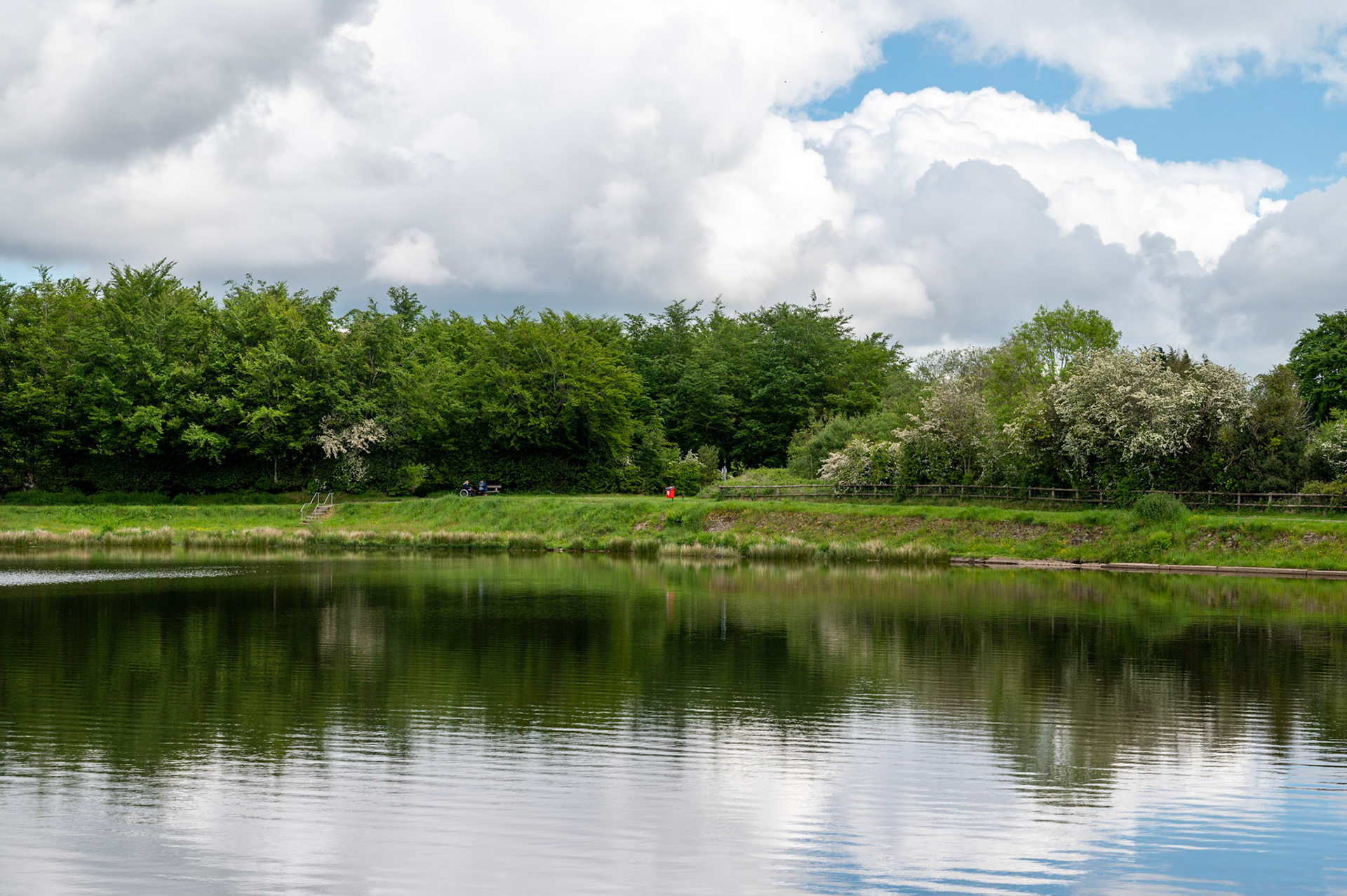 Clouds and blue sky reflected in Pen Y Fan Pond near Blackwood, South Wales, UK