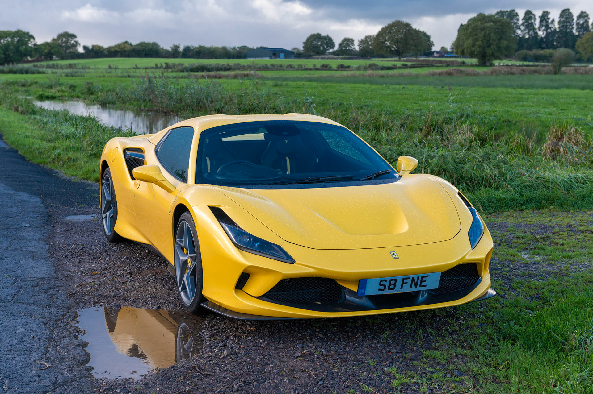 Yellow Ferrari F8 Spider photographed on the Gwent Levels, Castleton, South Wales, UK.
