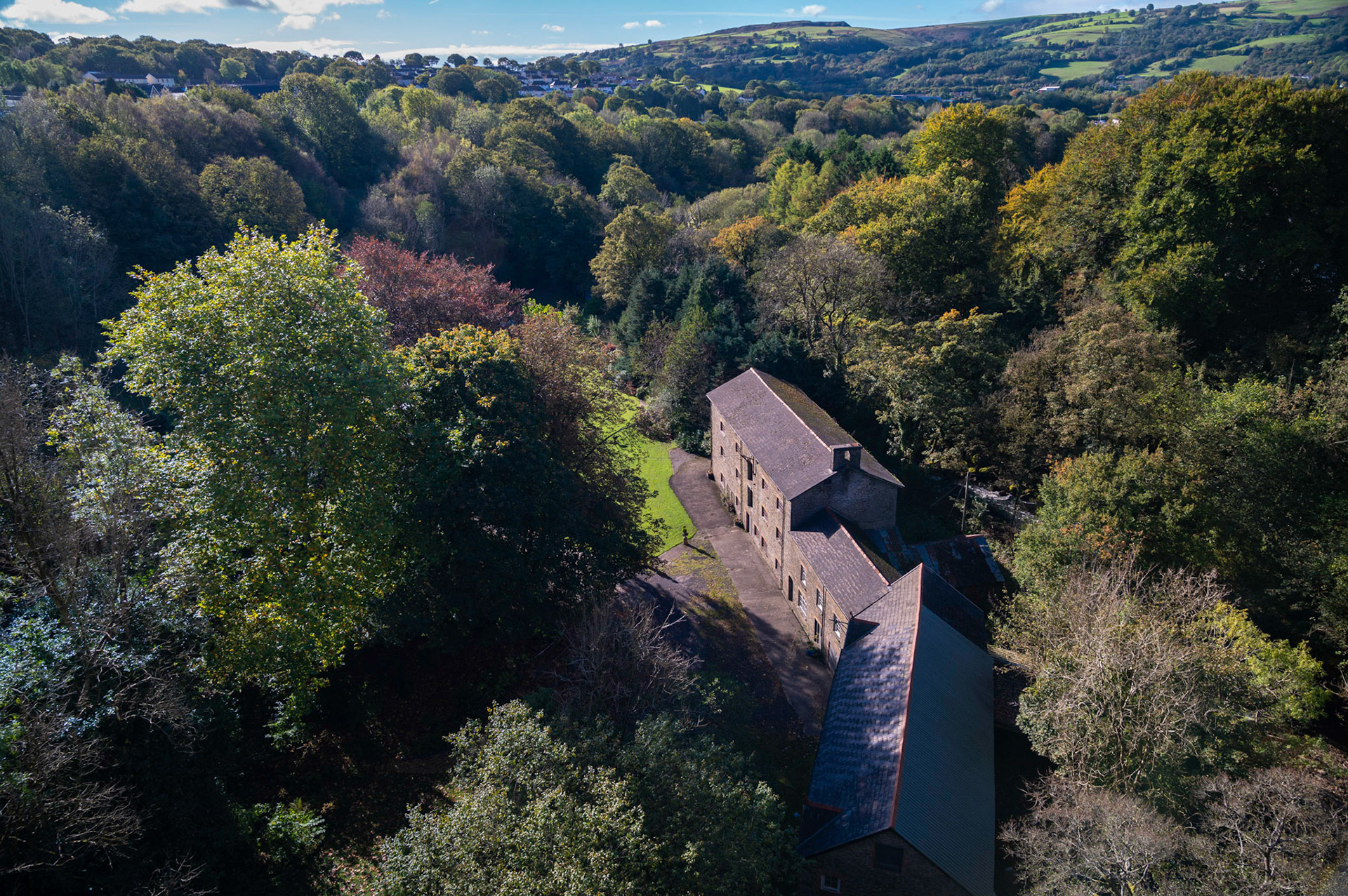 The Maesycwmmer Mill, South Wales, UK, viewed from the top of Hengoed viaduct,