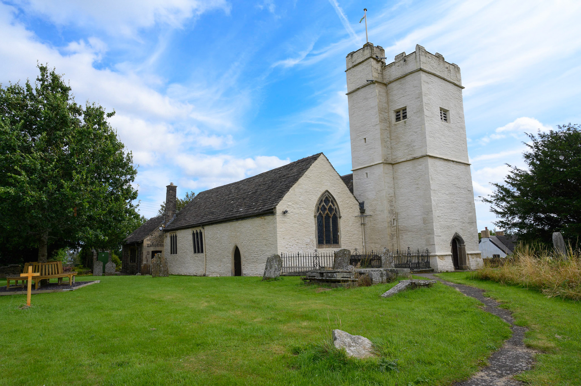 St Sannan’s Church and graveyard, Bedwellty, South Wales, UK against a blue summer sky.