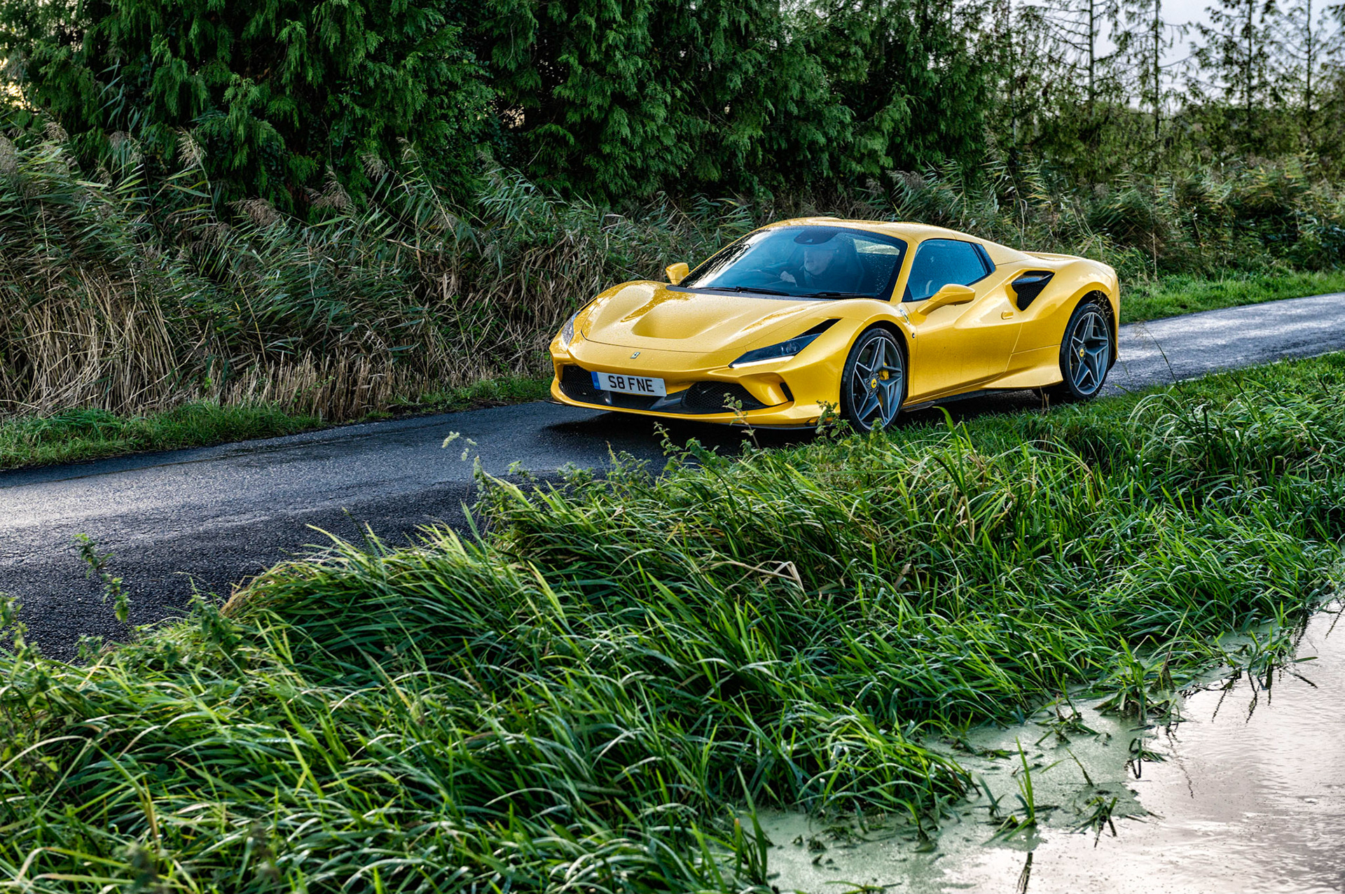 Yellow Ferrari F8 Spider photographed on the Gwent Levels, Castleton, South Wales, UK.