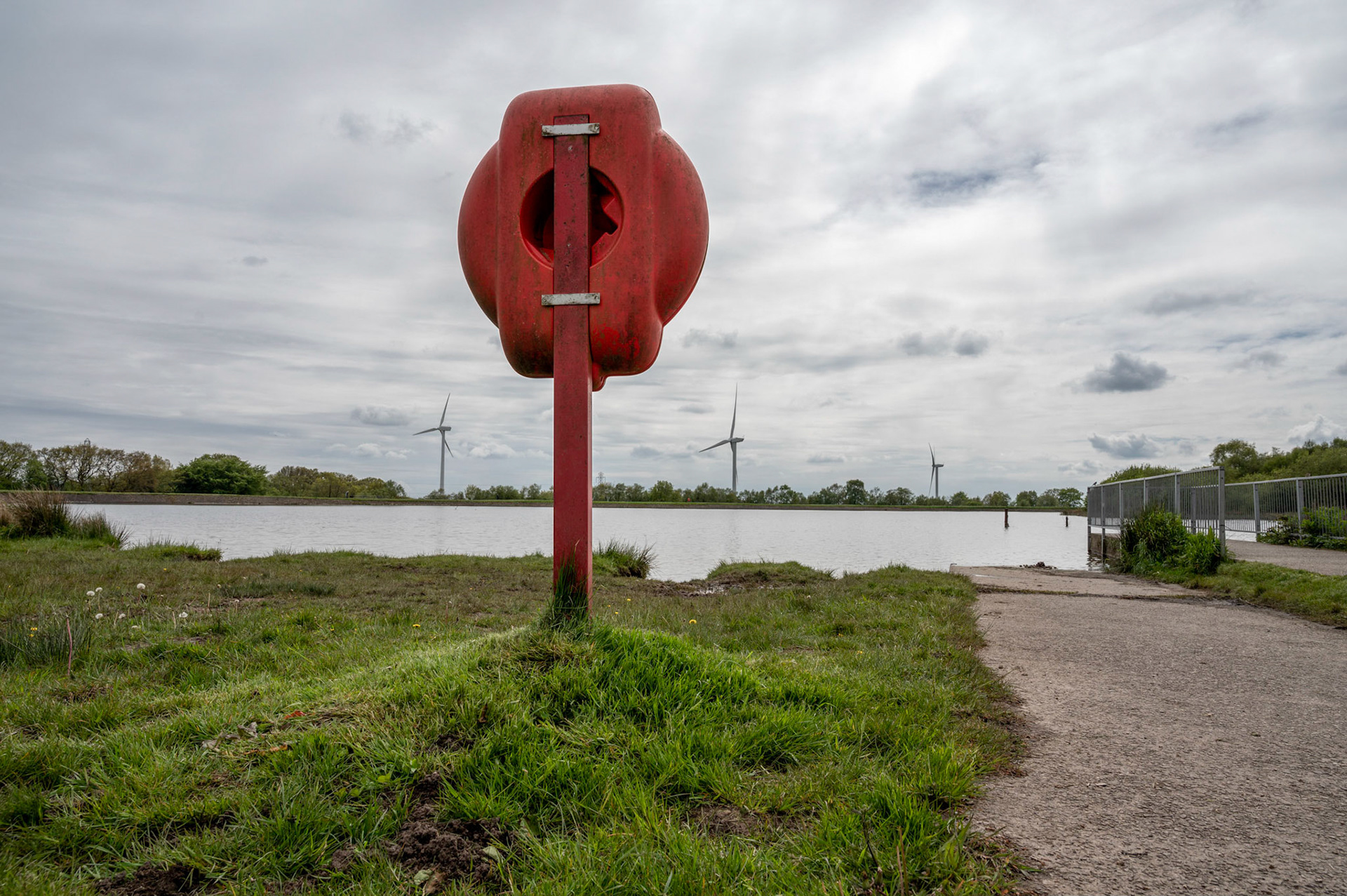 Wind turbines and life belt station at Pen Y fan Pond near Blackwood, South Wales.