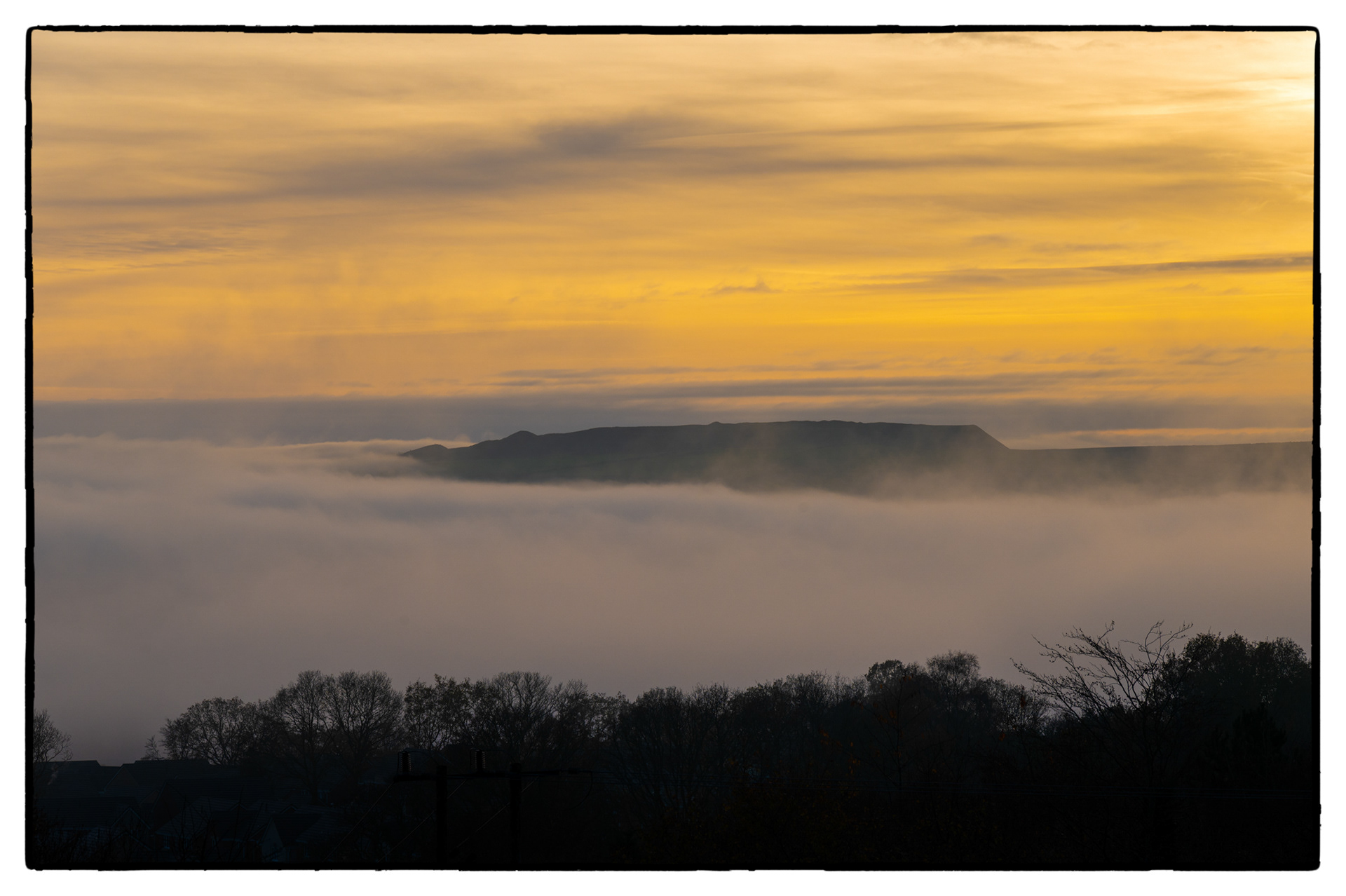 A fog bank lies in The Rhymney Valley, South Wales, UK