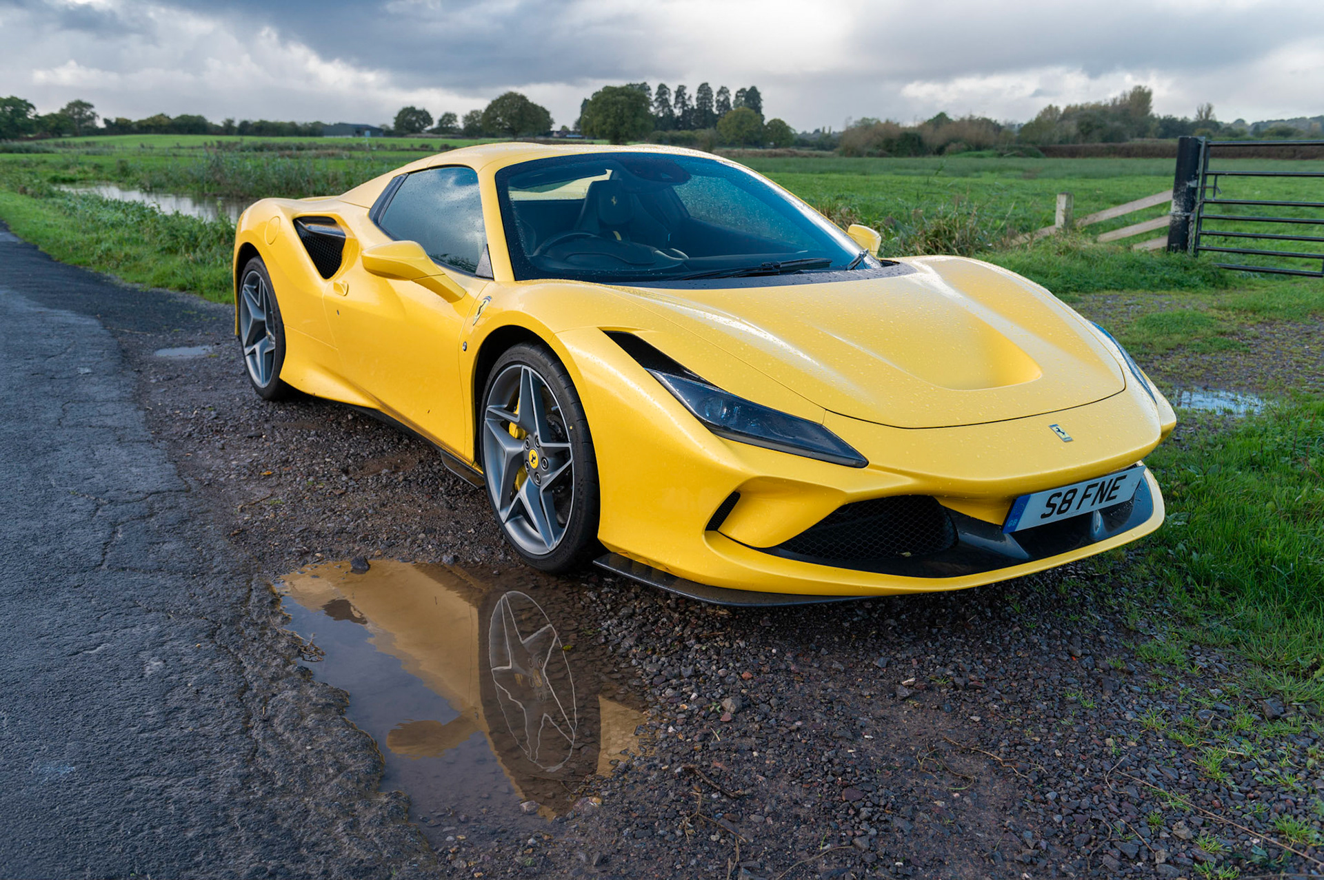Yellow Ferrari F8 Spider photographed on the Gwent Levels, Castleton, South Wales, UK.