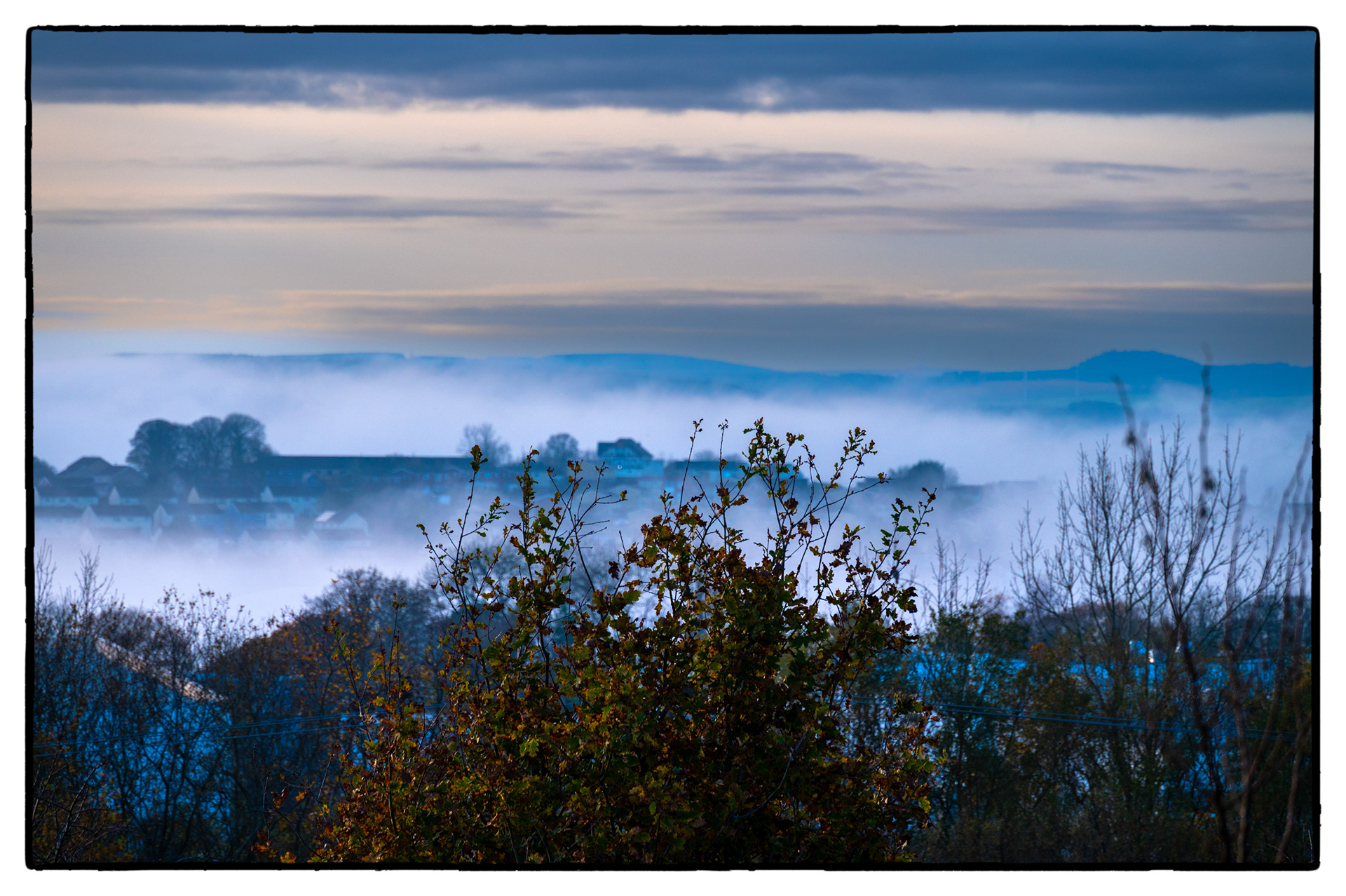 A fog bank lies in The Rhymney Valley, South Wales, UK