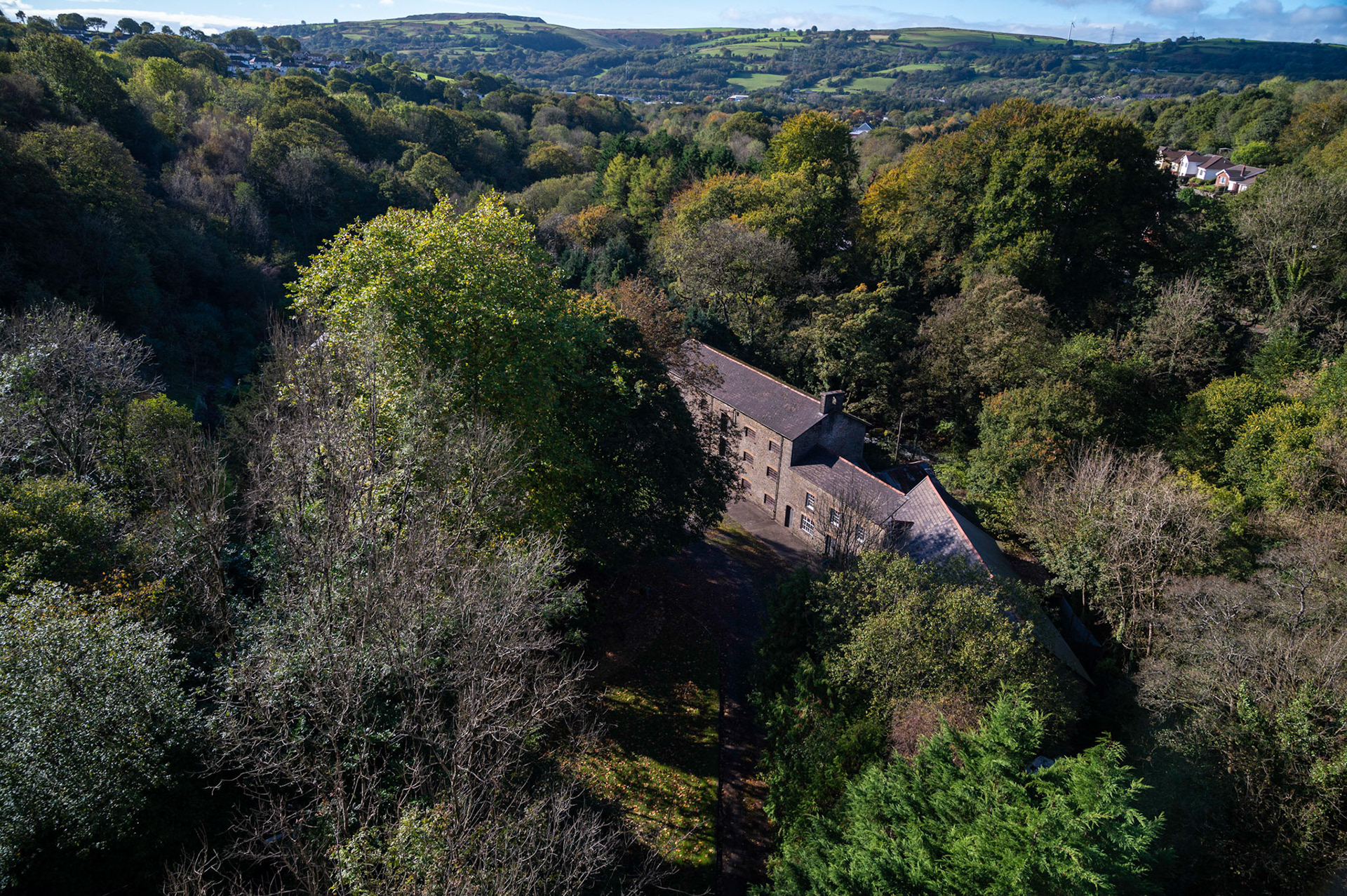 The Maesycwmmer Mill, South Wales, UK, viewed from the top of Hengoed viaduct,