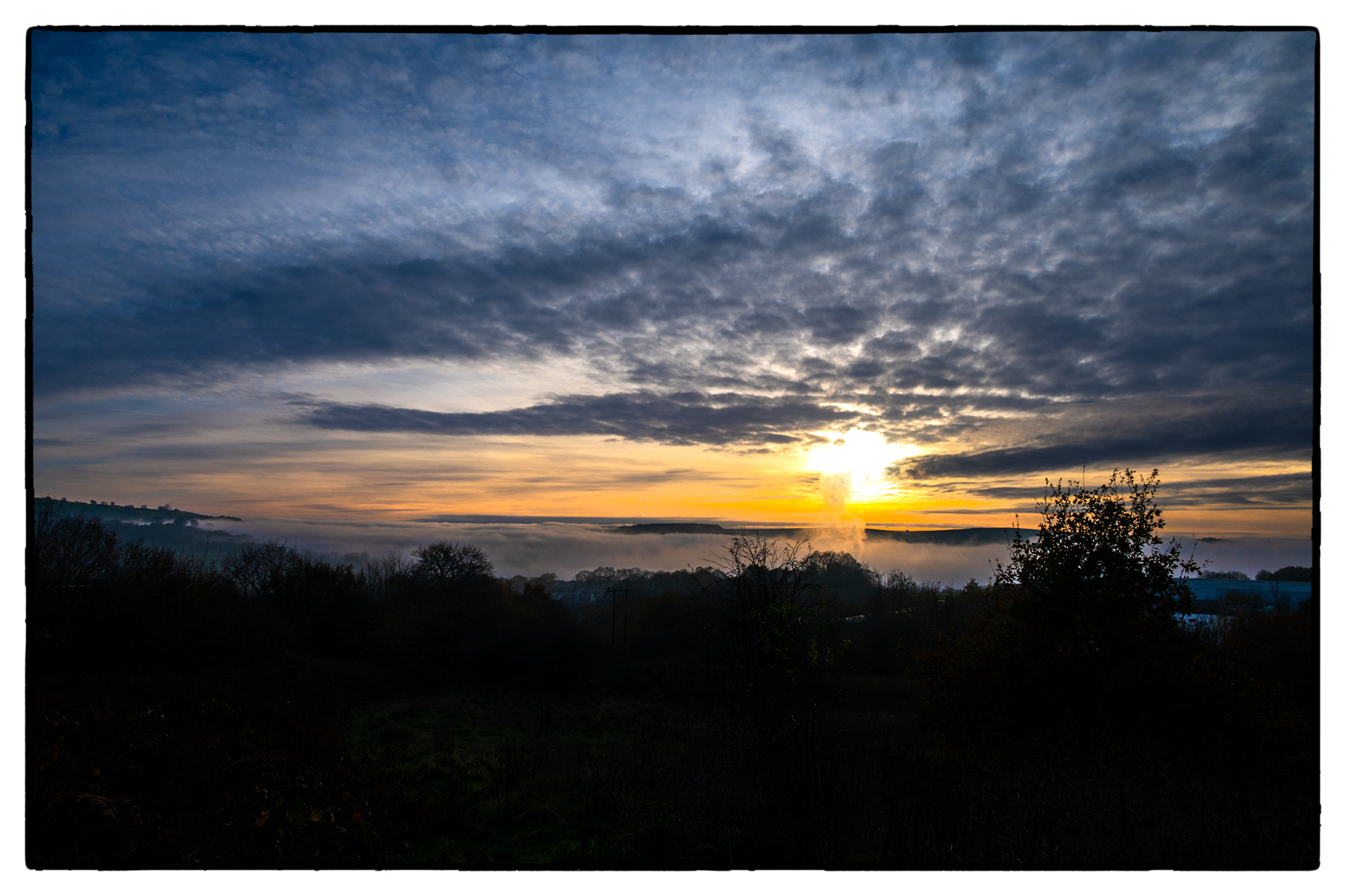A fog bank lies in The Rhymney Valley, South Wales, UK