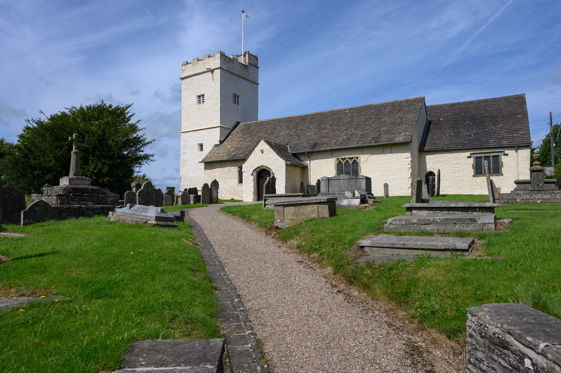 St Sannan’s Church and graveyard, Bedwellty, South Wales, UK against a blue summer sky.