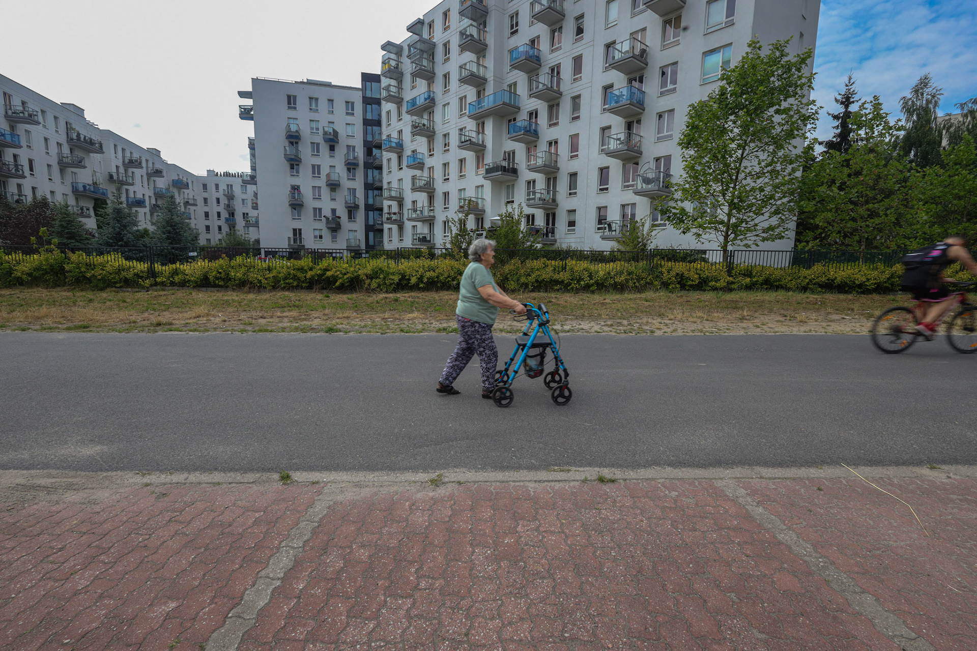 80 year old Ms Teresa walks on the modern estate where she lives