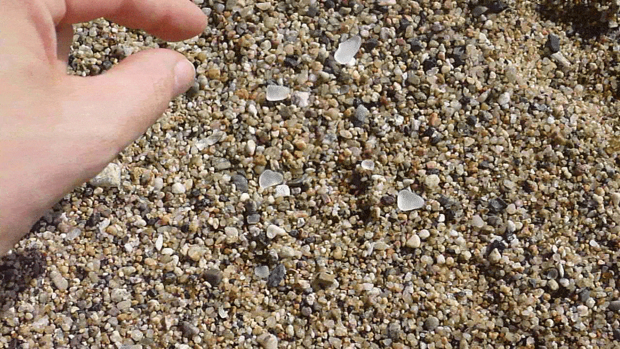 A collection of sea glass gathered from Barceloneta beach, displaying the frosted textures and ocean-like colours