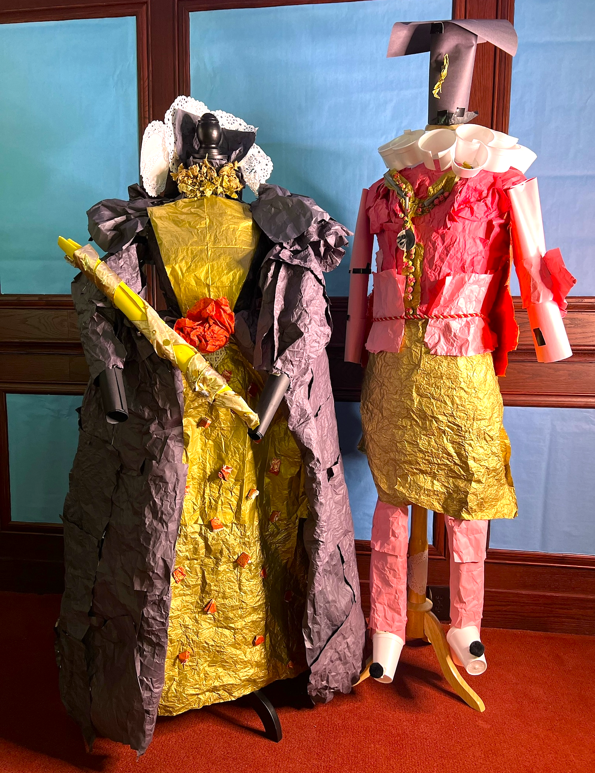 Typical clothing of Queen Elizabeth I and William Shakespeare made from paper.