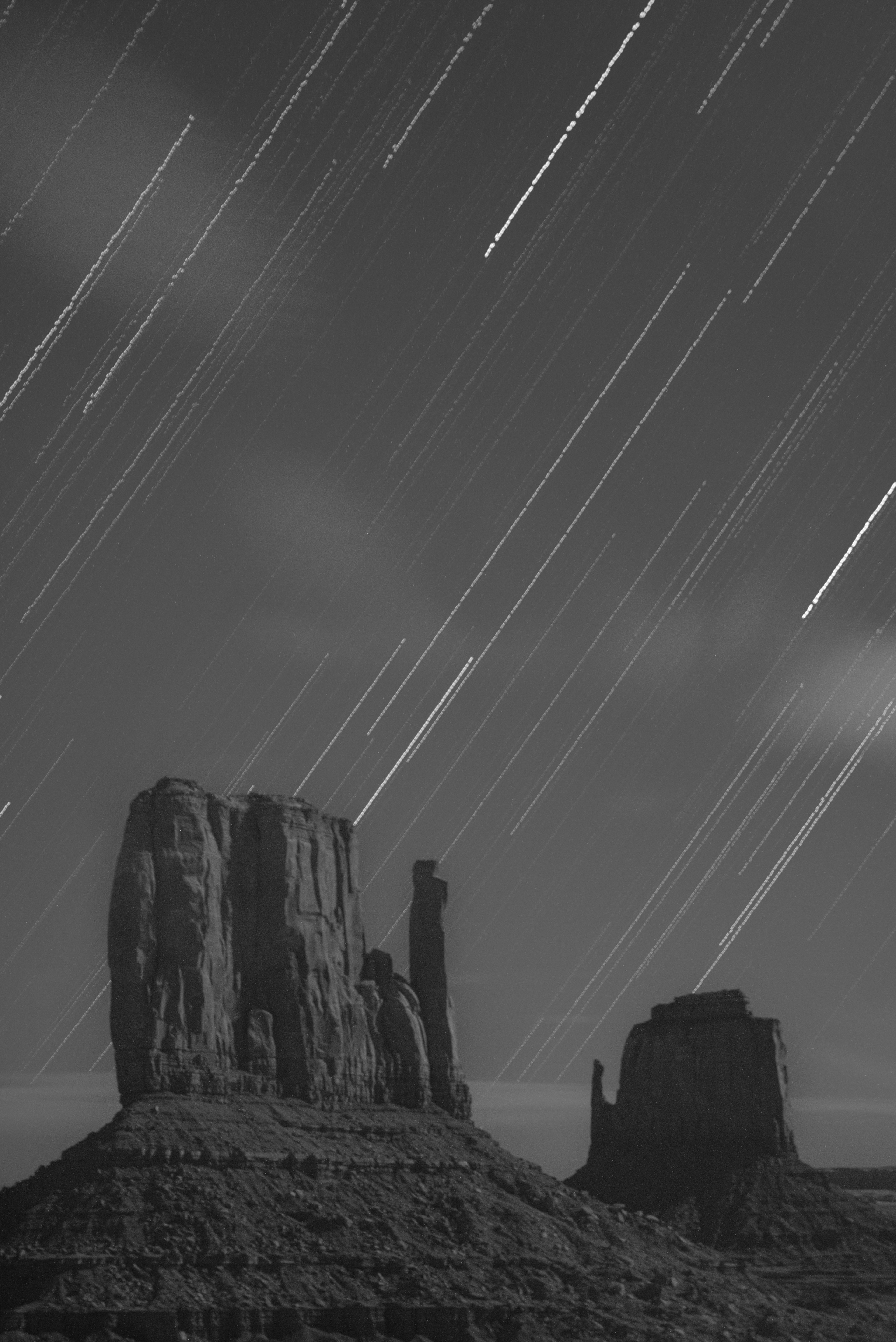 Infrared star trails and the Left and Right Mittens. Monument Valley, AZ.