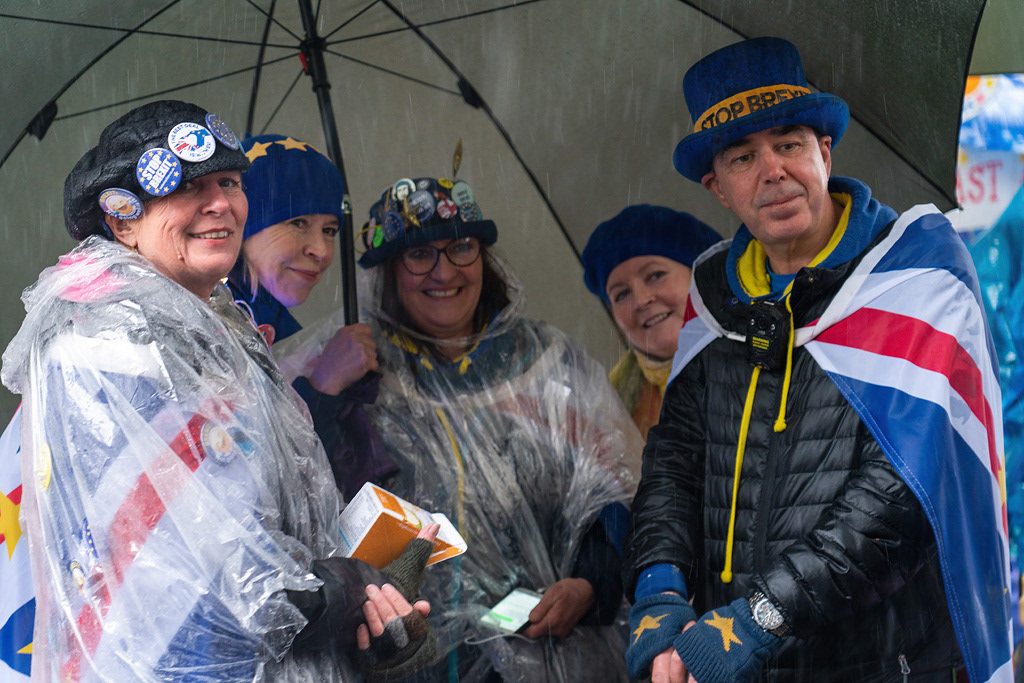 Steve Bray and fellow 'remain' protesters sheltering from the rain