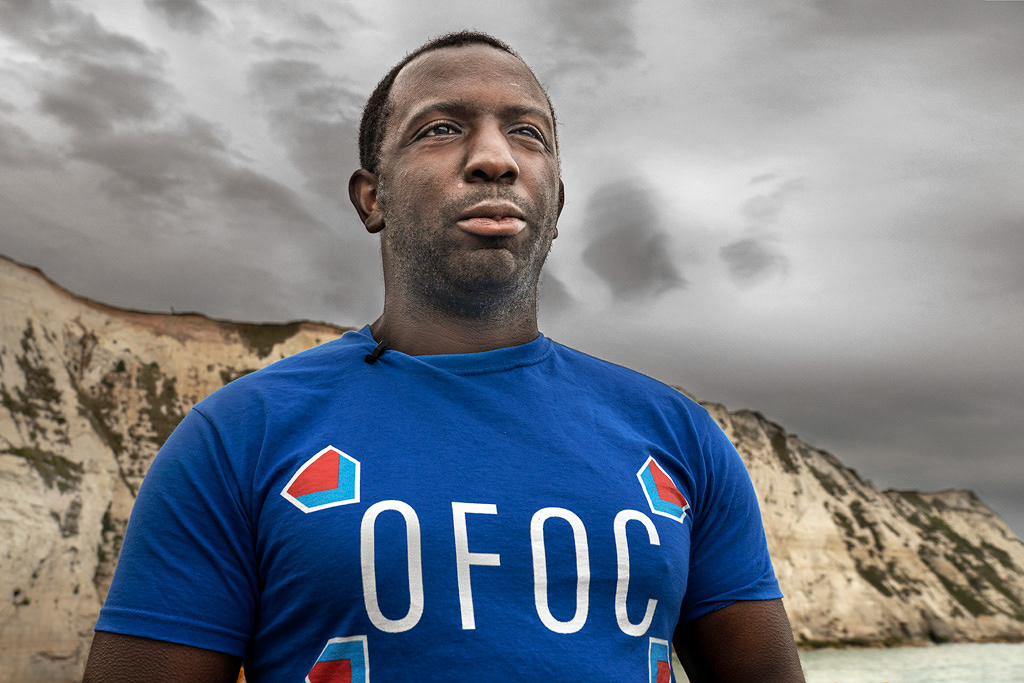 Anti-Brexit campaigner Femi Oluwole gazes thoughtfully at France, with the white cliffs of Dover behind him.