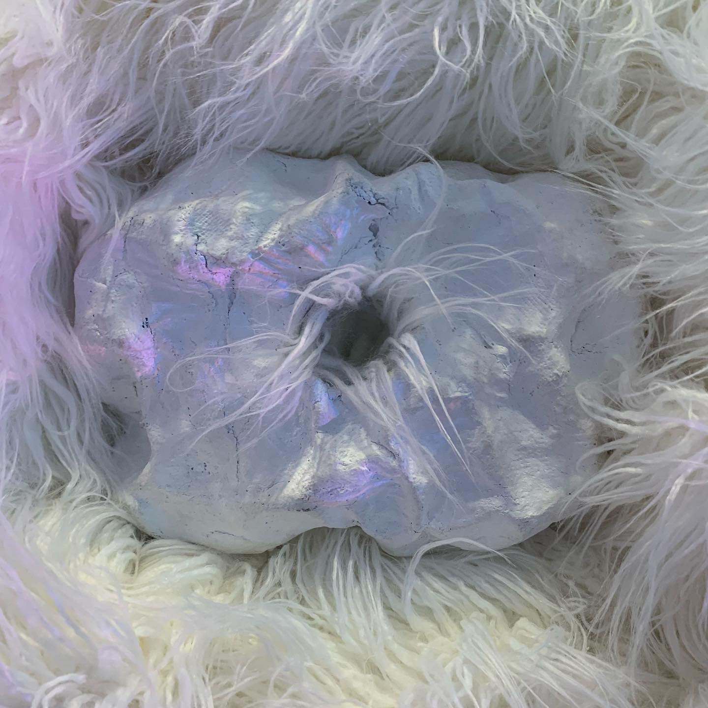 Detail of scent vessel within shaggy texture, can be taken off the wall and held