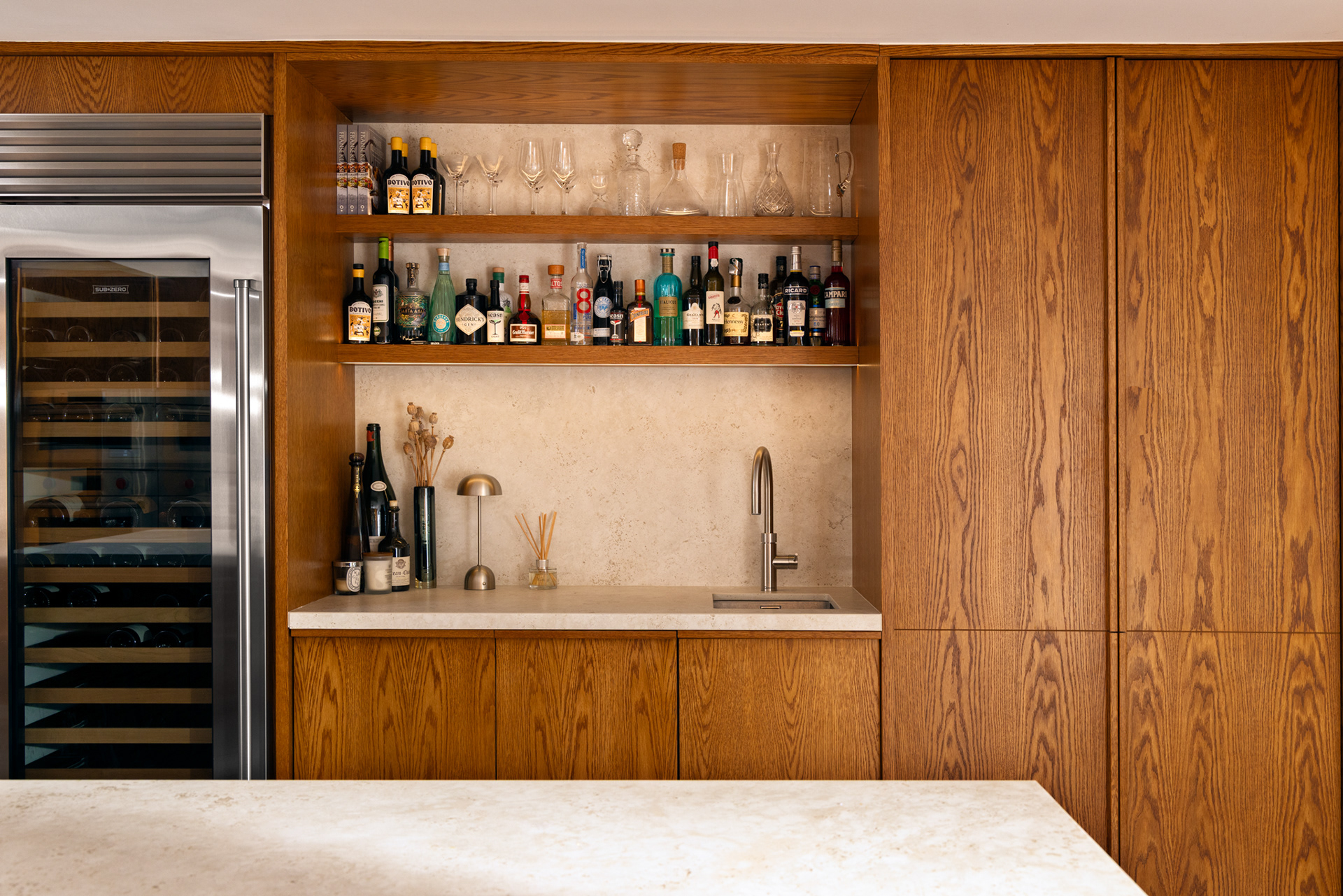 Custom cabinetry framing a full-height Sub-Zero refrigerator, combining performance with timeless design.