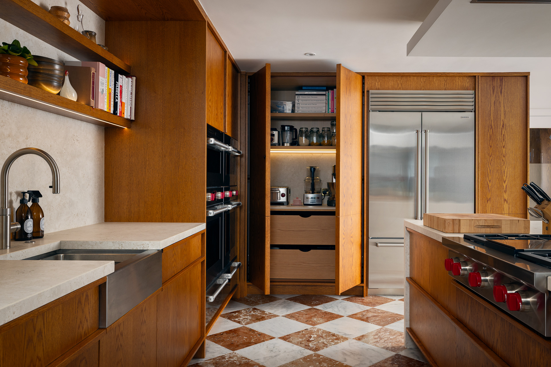 Bespoke oak cabinetry complemented by premium Sub-Zero refrigeration and luxury integrated storage.