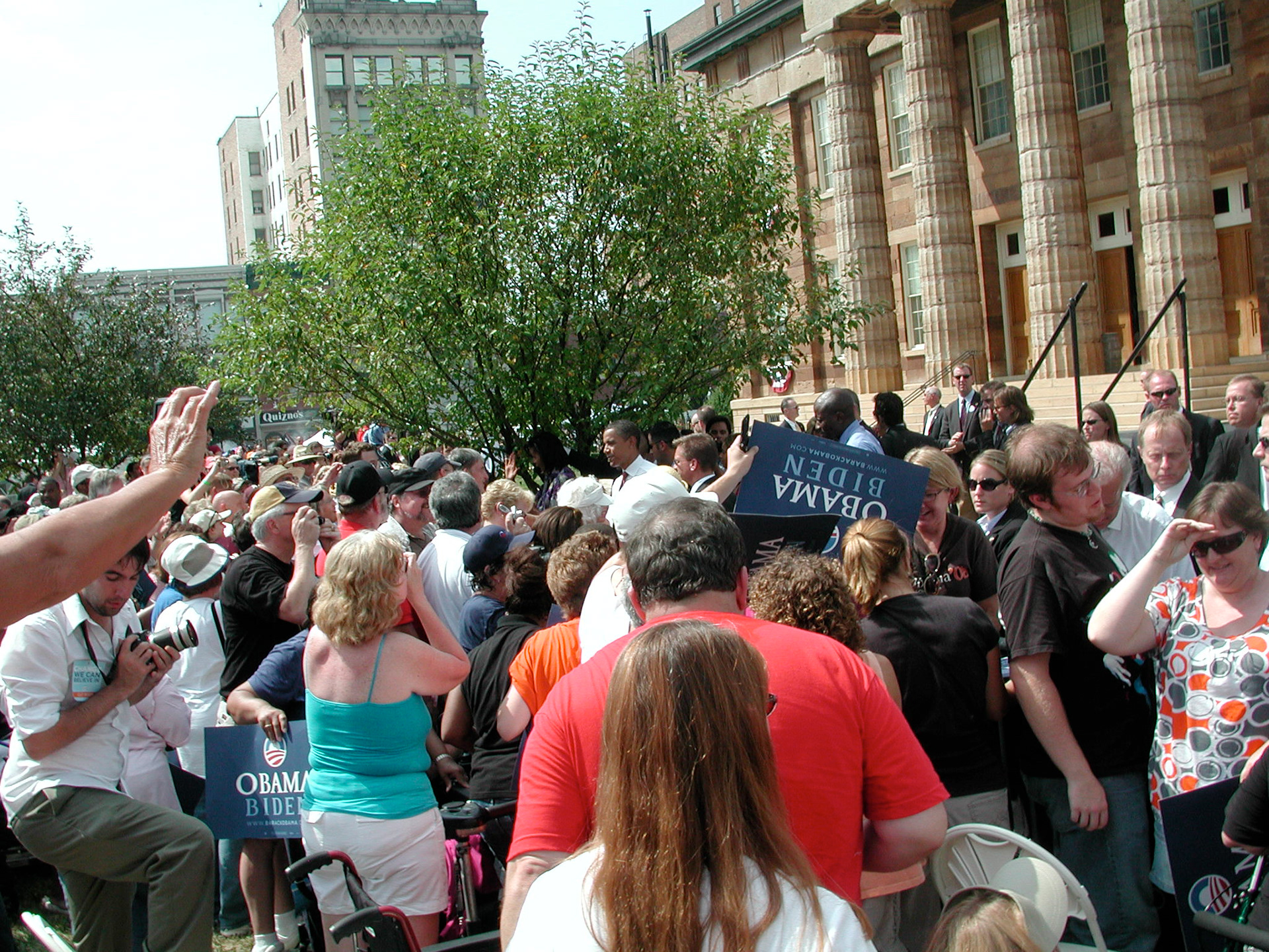 Obama listens to a crowd member