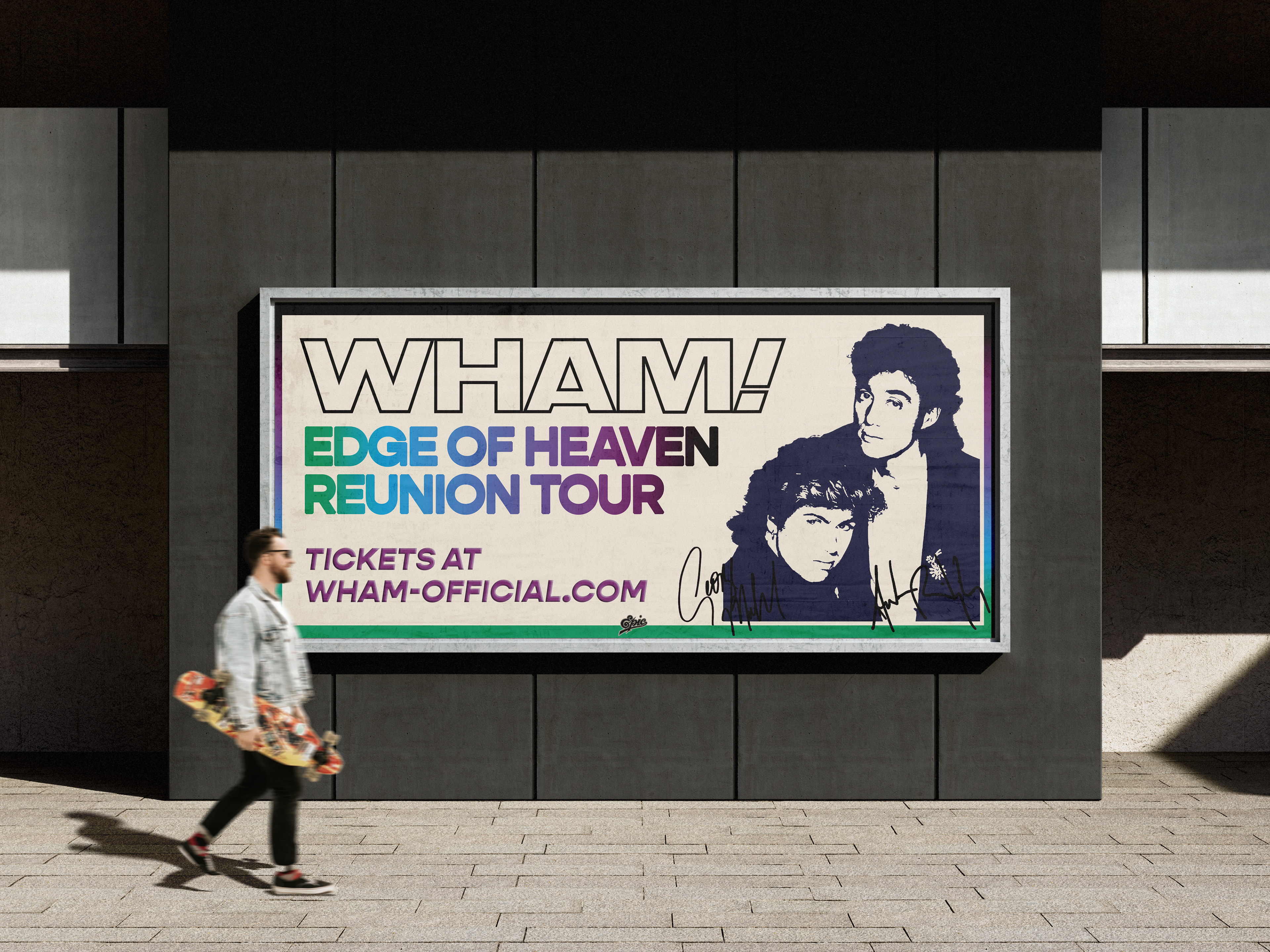 Wham! branded 80s tour billboard on exterior dark grey wall beside a sidewalk. A man with a skateboard is walking past it.