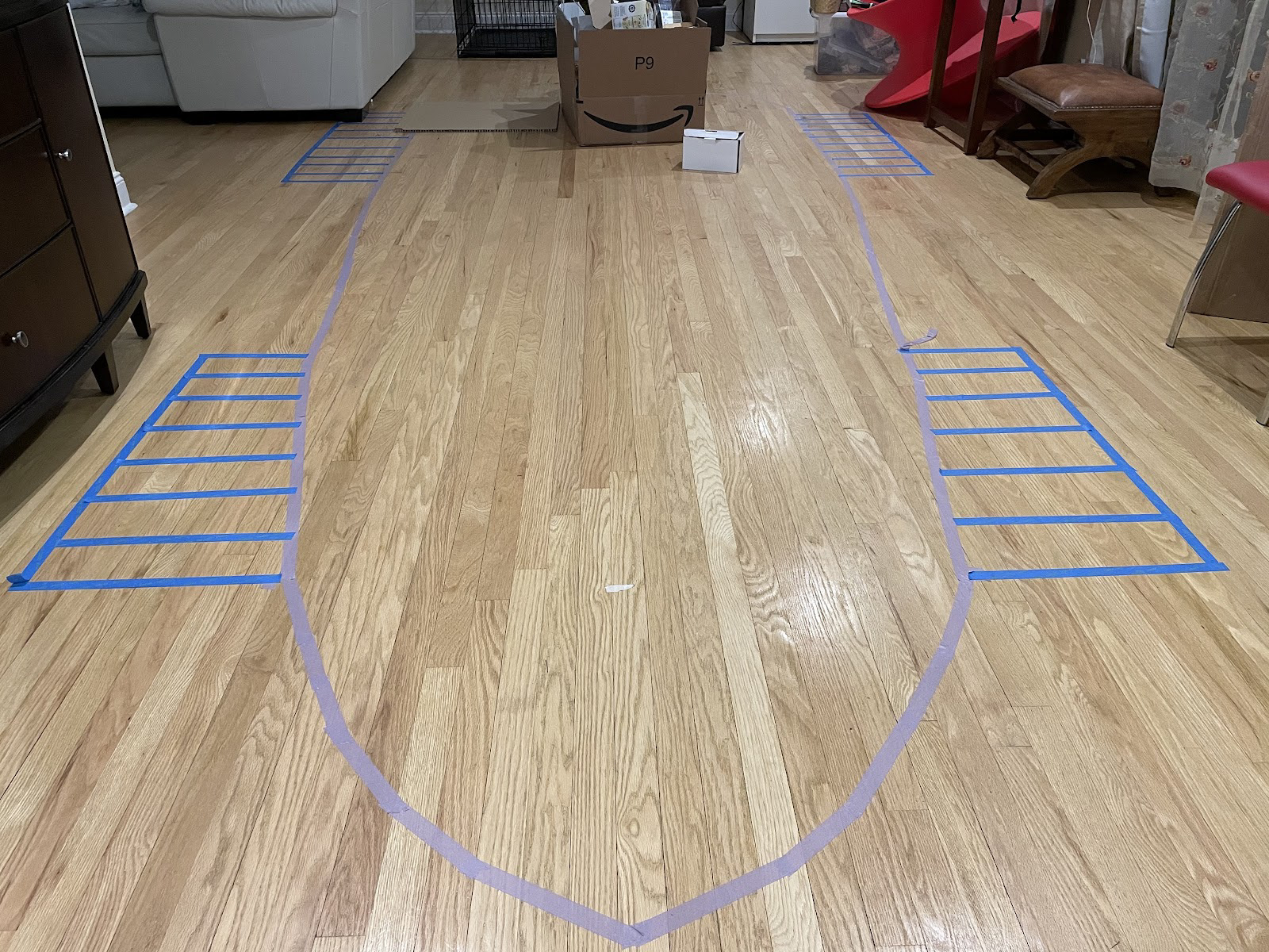 The purple tape is the shape of the body, an the blue tape is the tracks. The boxes is used to show where some cargo space would be and provide scale.