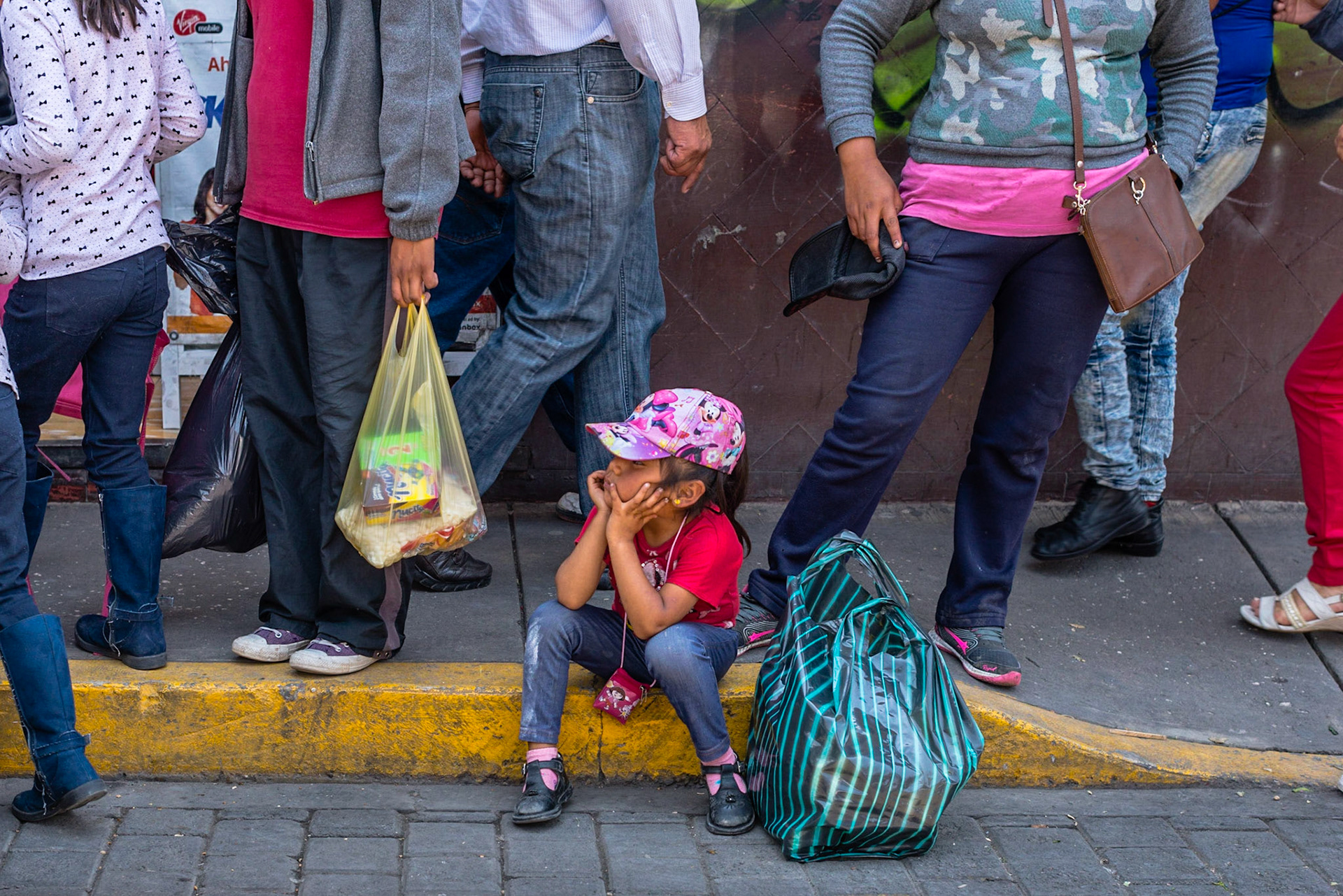 The streets of San Pedro Cholula early in the afternoon get crowded around the main market, people wait for a 'combi' the most popular transport car in Mexico.