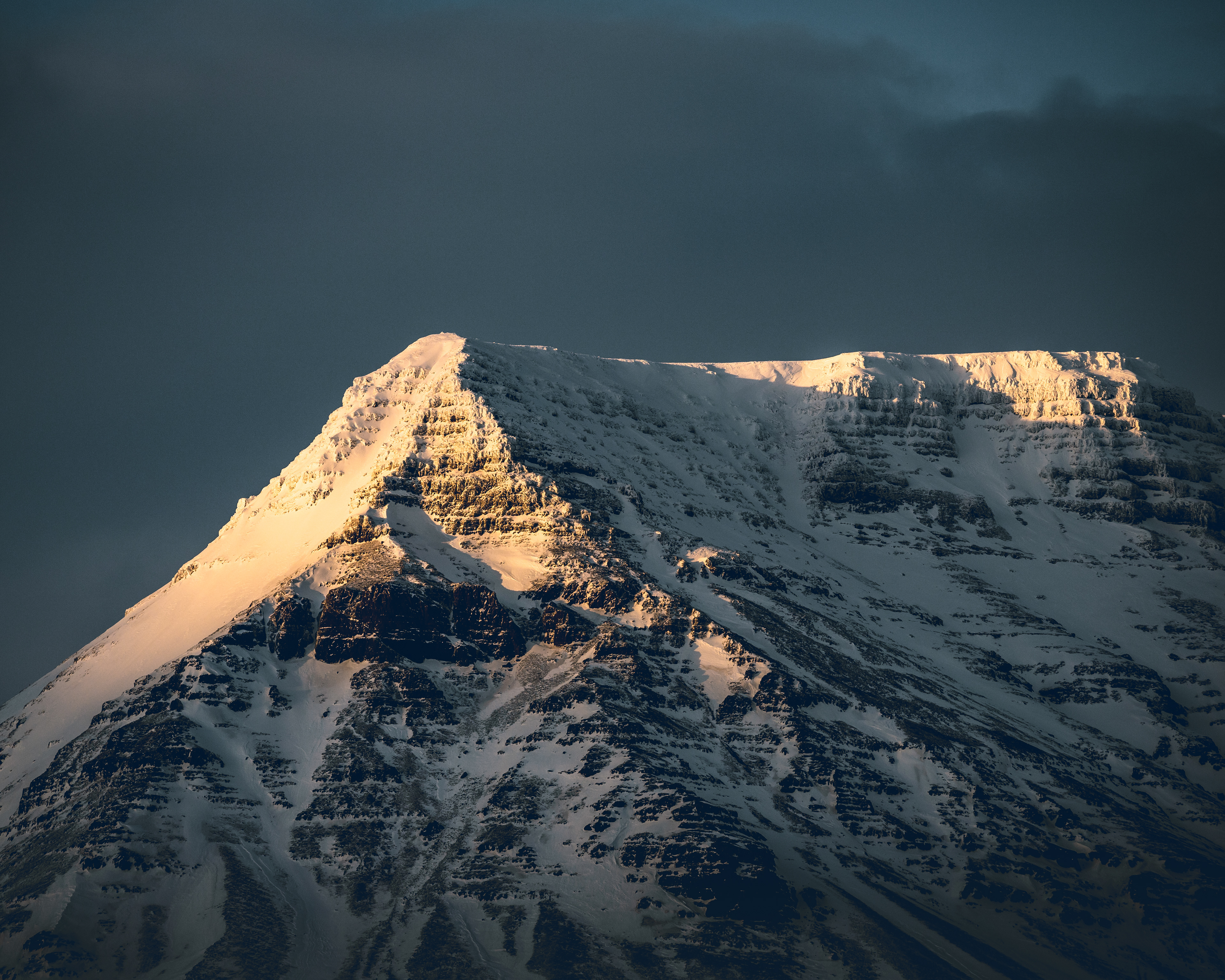 A mountain top bathing in the late afternoon sun