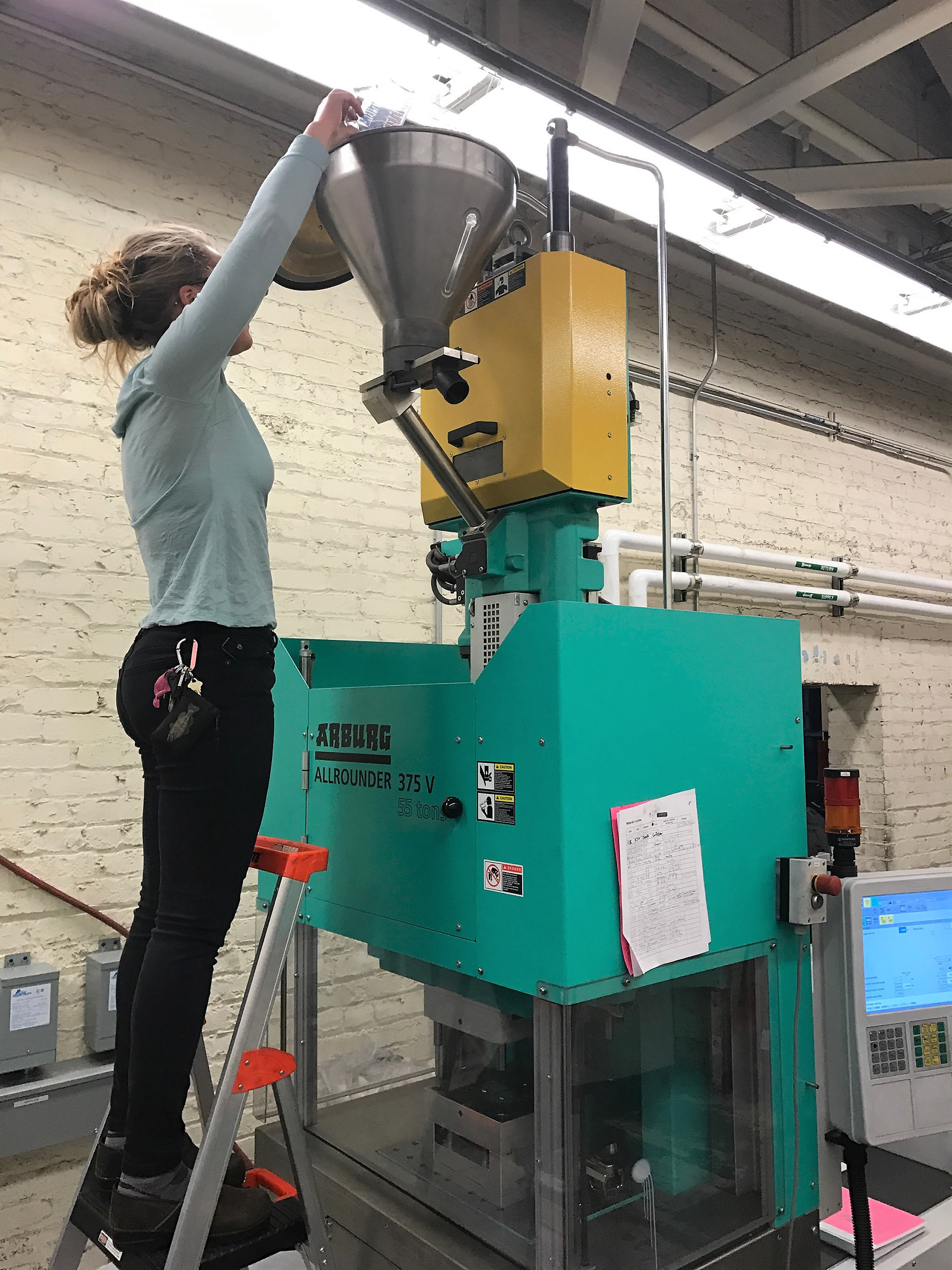 Loading raw plastic into the injection molder