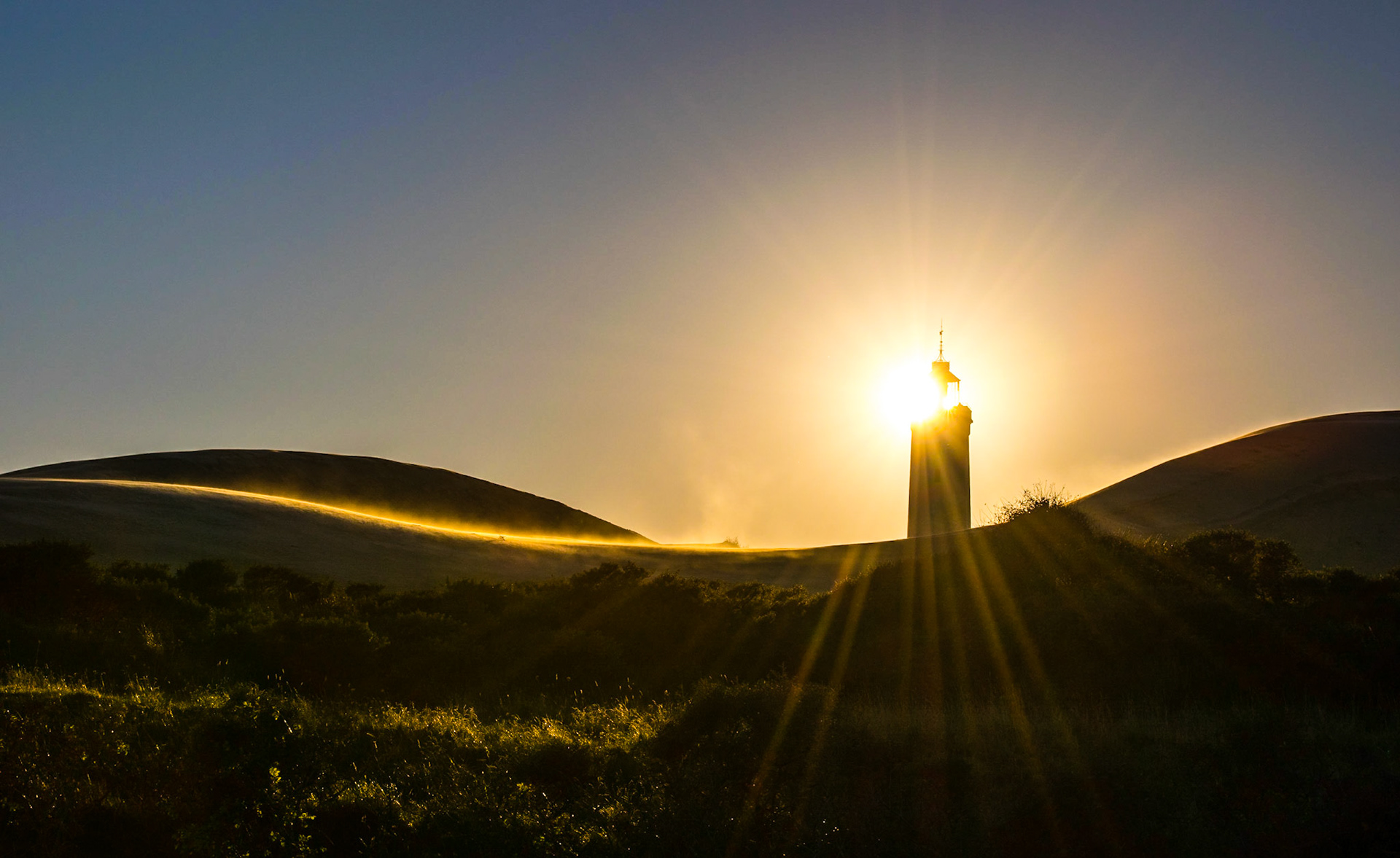 Sun is setting over Rubjerg Knude Lighthouse in Denmark