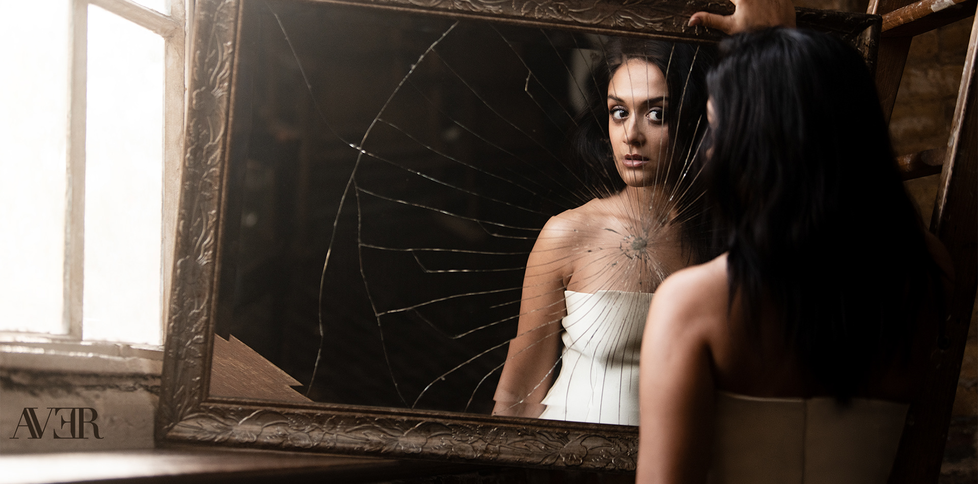 Amy-Leigh Hickman gazes into a mirror for AVER Magazine