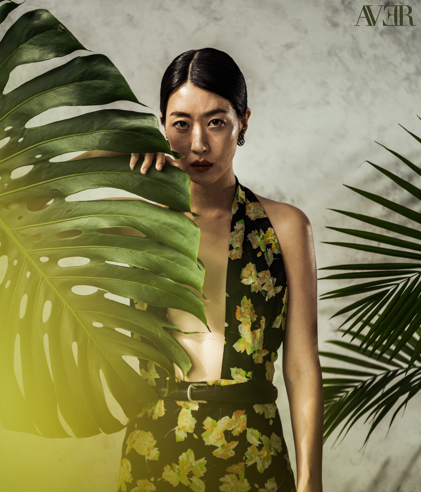 Jiyoung Chang holds a monstera leaf