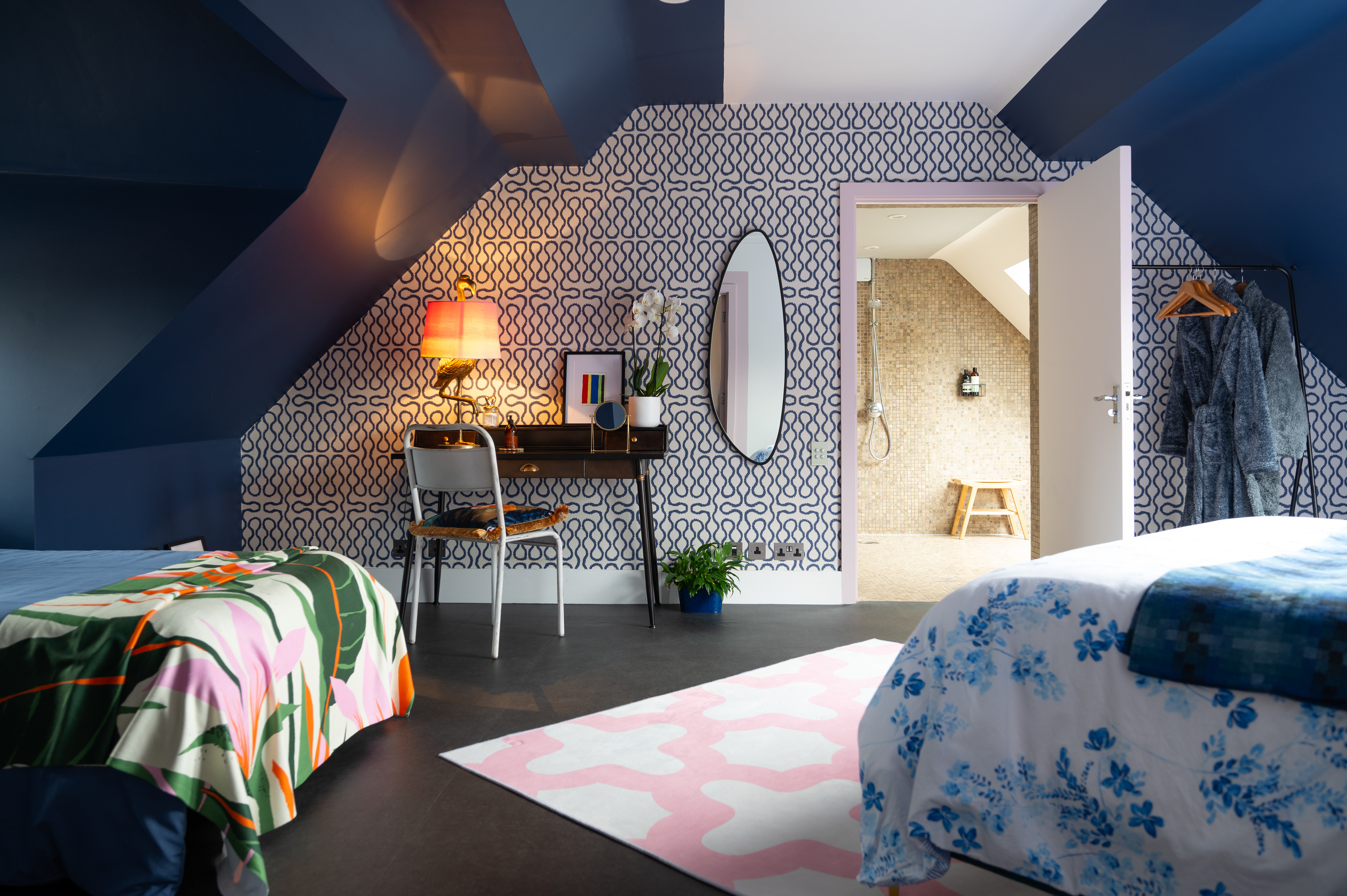 A beautifully designed bedroom with views to the en suite bathroom in the background.