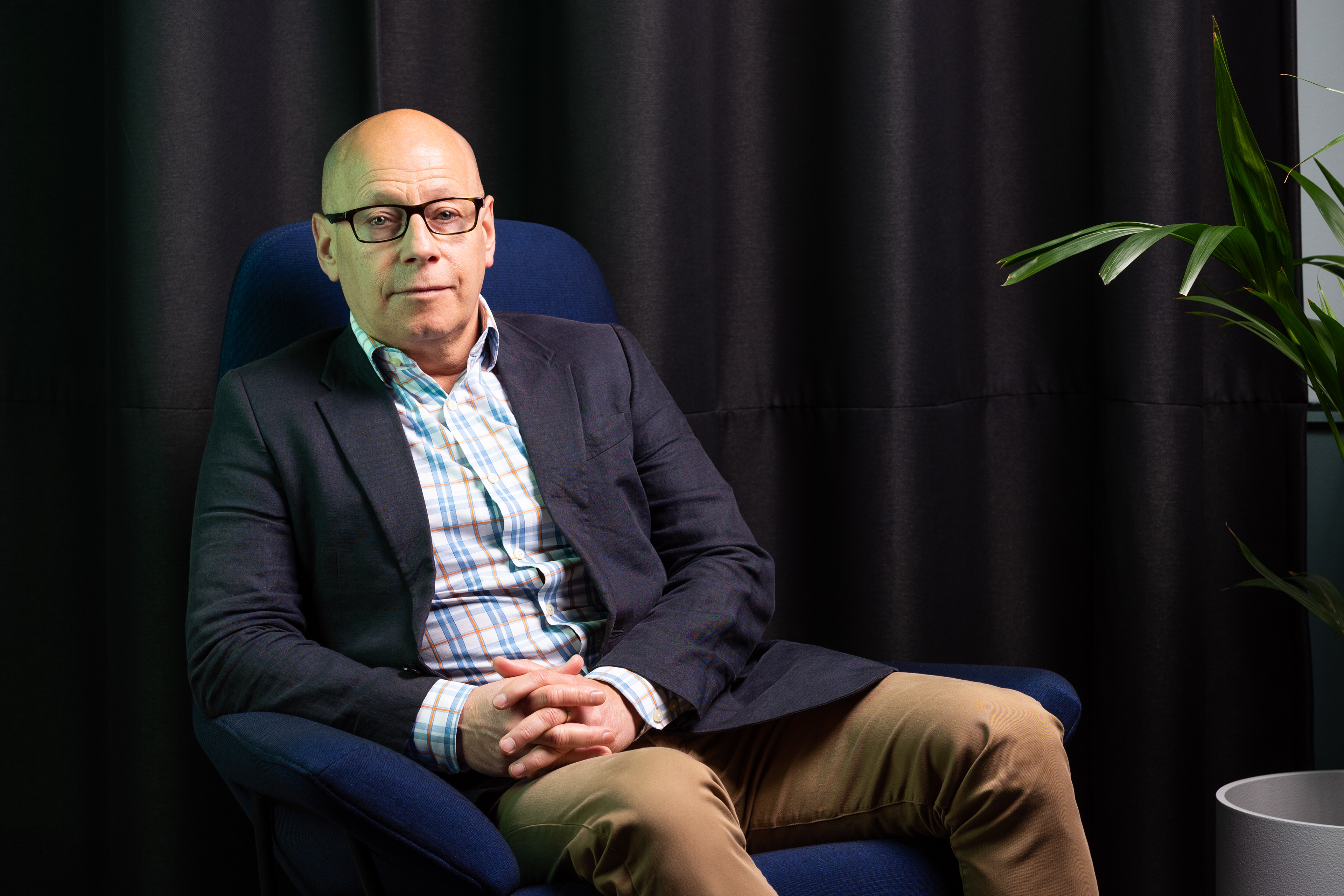 Portrait shot of a man wearing sitting in a chair