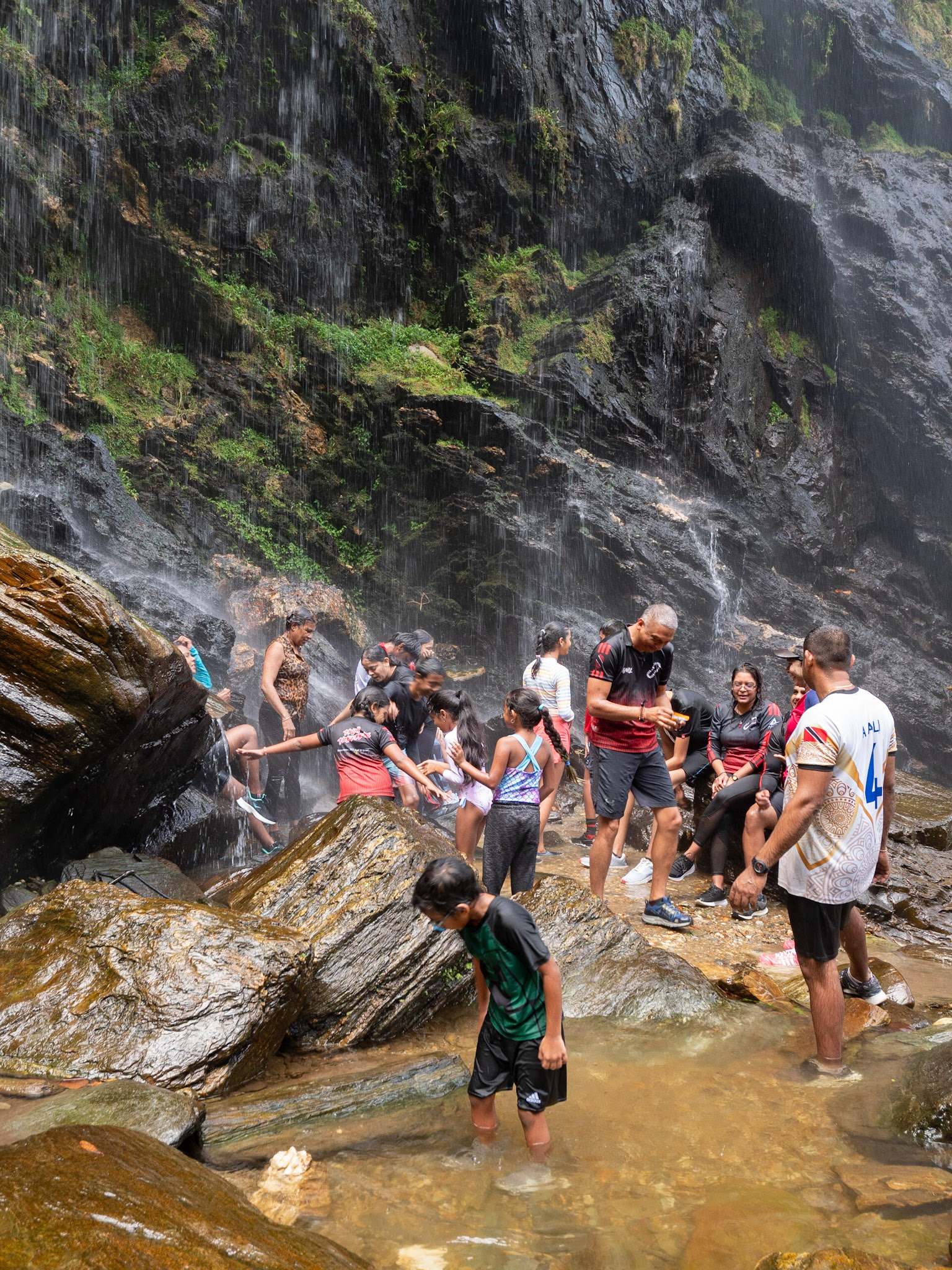P1123205 Having fun under the spray of the waterfall