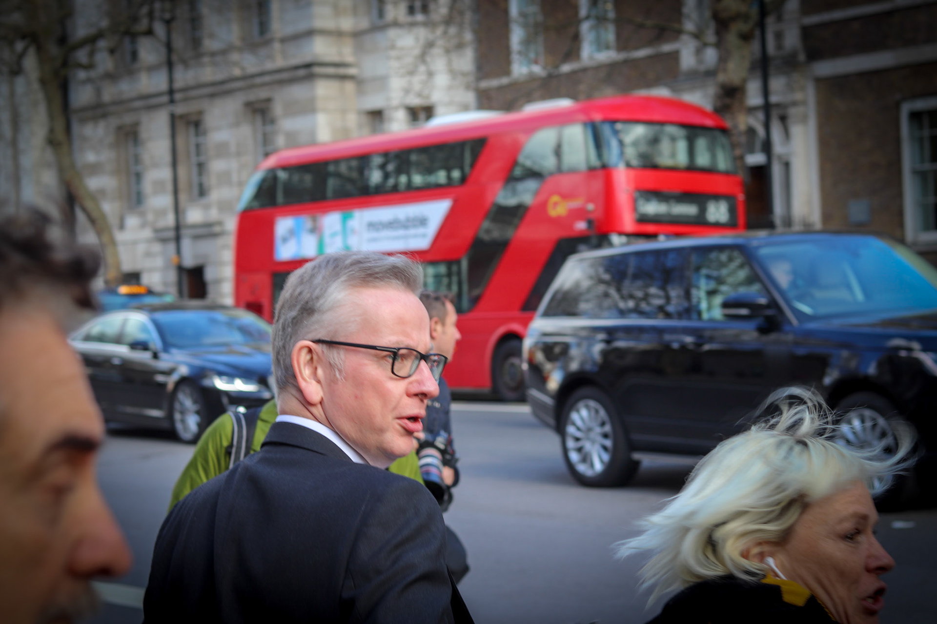 Michael Gove MP crosses Whitehall