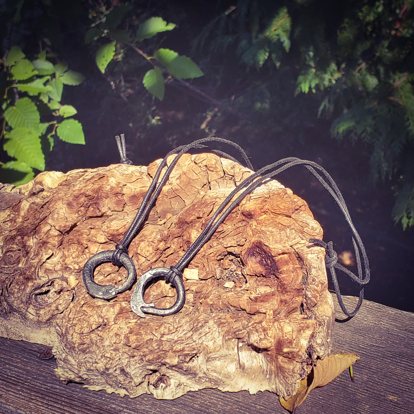 Matching ouroboros pendants