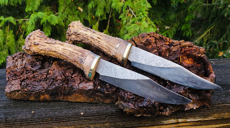 1084 blades, moose tine grips, oak burl and brass